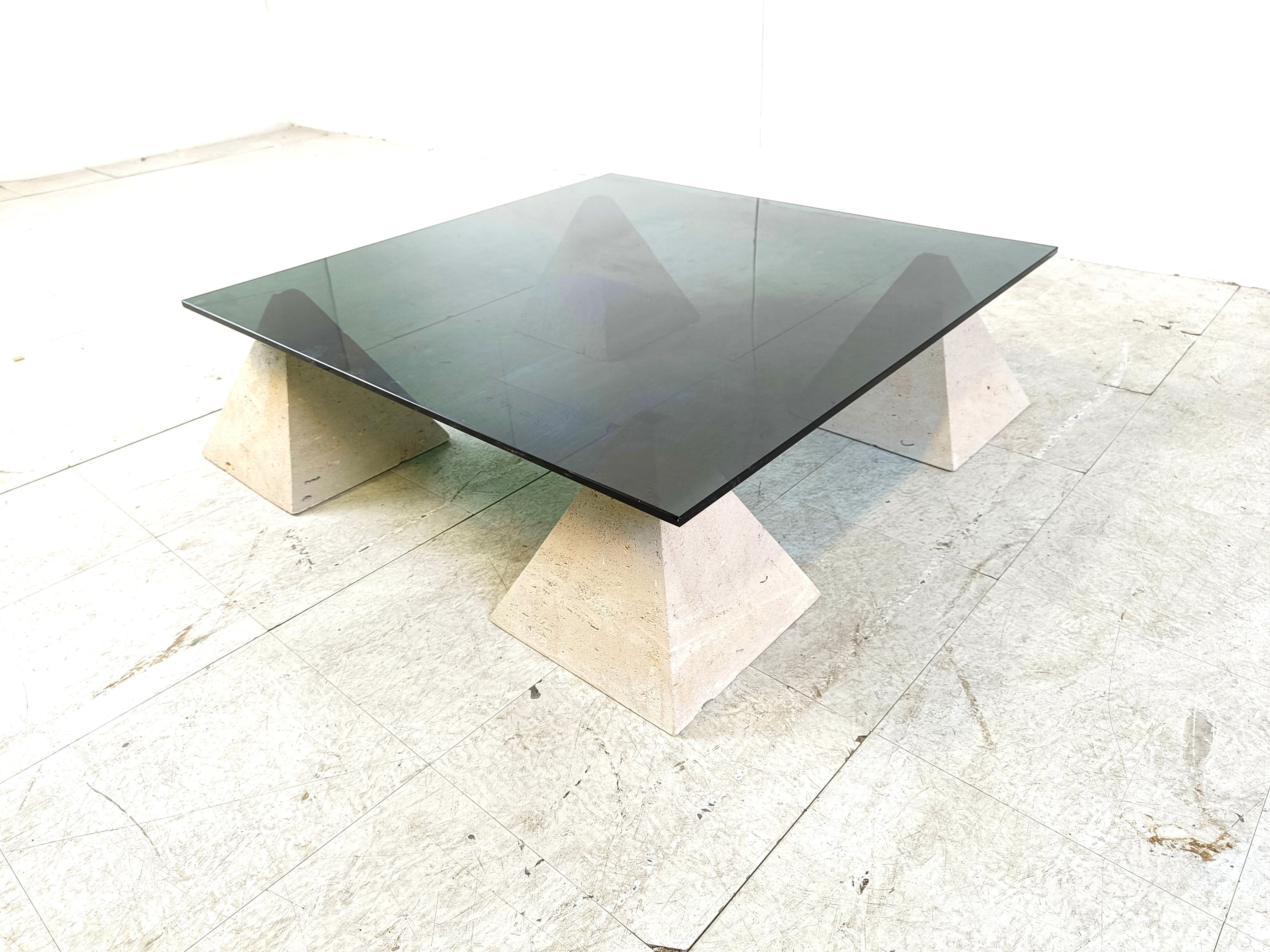 Vintage coffee table consisting of 4 stone pyramid shaped bases with a thick smoked glass top.

Beautiful, timeless design.

1970s - Belgium

The table was made by a local artist.

Height: 26cm
Width: 90cm
Depth: 90cm

Ref.: 203210