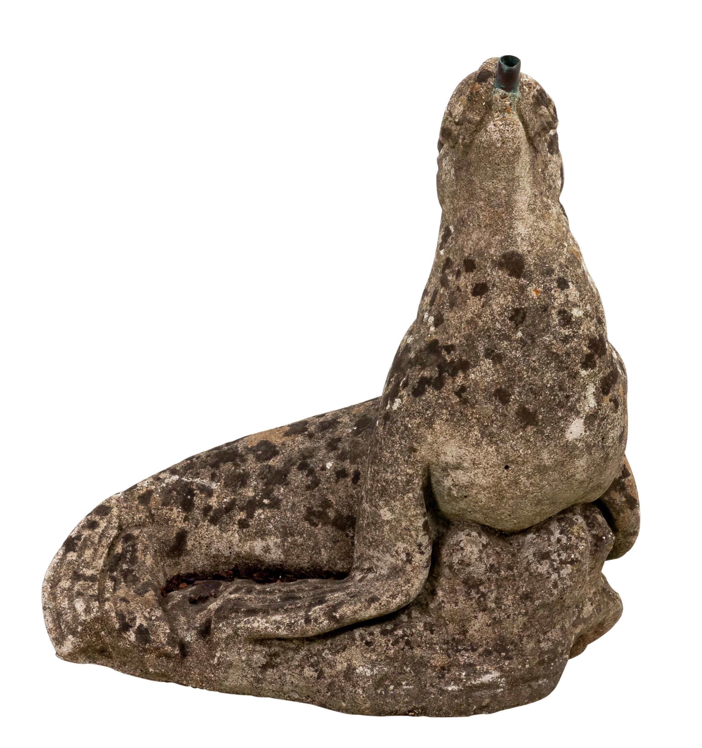 Circa mid-20th century vintage cast stone garden water fountain ornament in the shape of a seal. Please note of wear consistent with age such as patina to the stone and oxidation to the metal due to exposure to the elements.