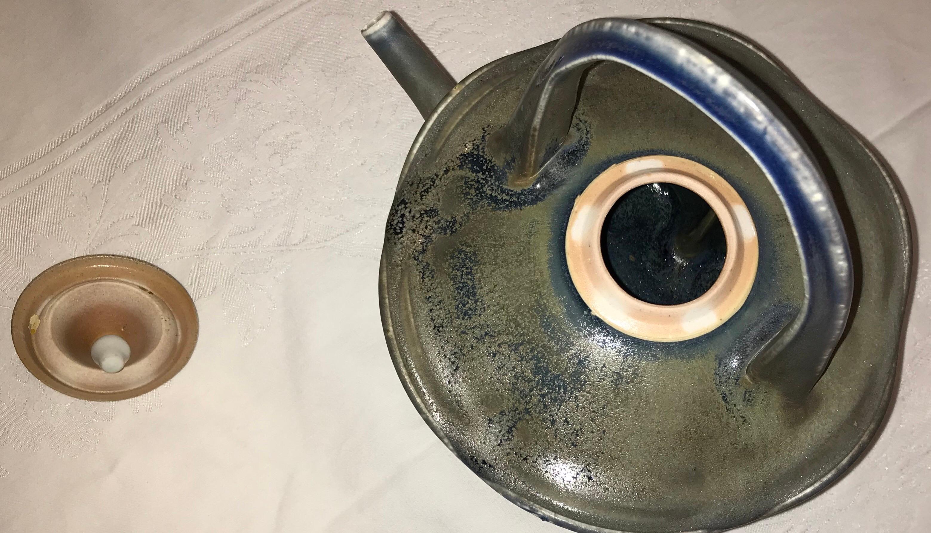 This unique naturalistic teapot, designed, decorated and fired by Stone Soldier Pottery in Jacksonville, Vermont, is hand-made in the forests of the Green Mountains.  The potter has created a whimsical yet sturdy teapot, reminiscent of forest shapes
