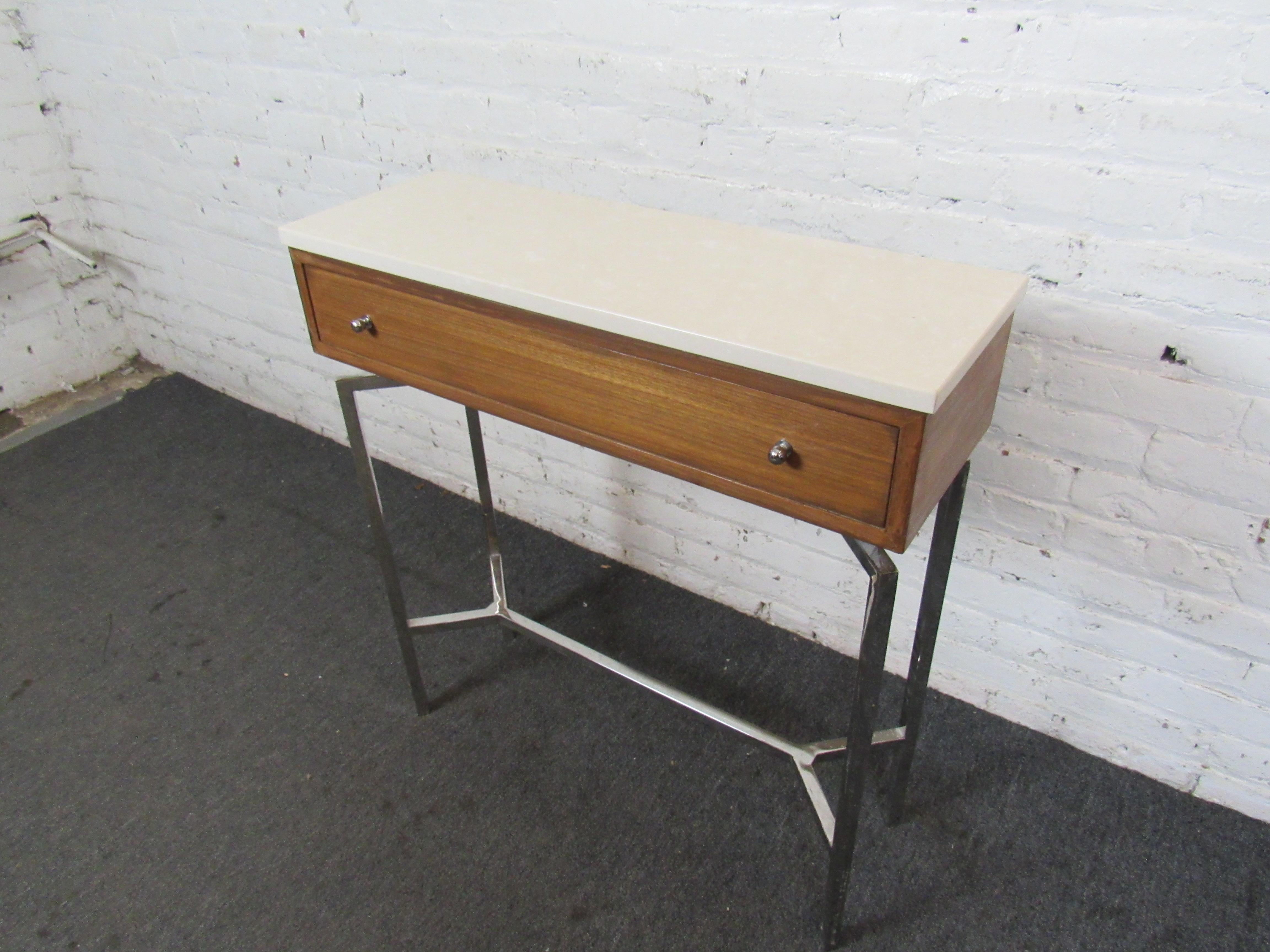 Vintage stone-topped console table by Mitchell Gold + Bob Williams, featuring chrome legs, rich woodgrain, a large drawer for storage, and a unique Mid-Century Modern design. Please confirm item location with seller (NY/NJ).