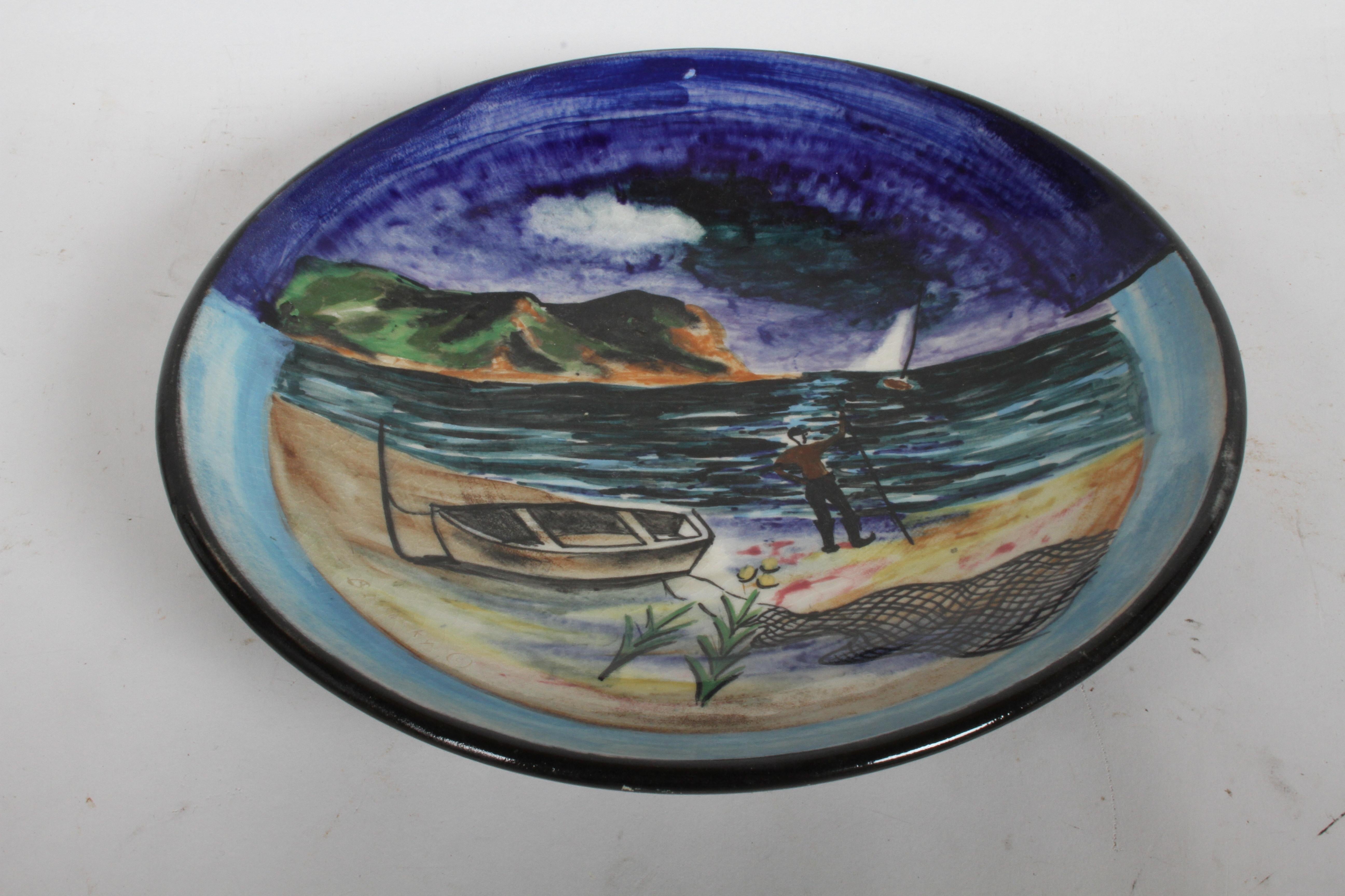 Artist Nicolai Cikovsky (1894-1984) Russian/American, hand painted ceramic charger for Stonelain circa 1940s, part of the (AAA) or Associated American Artists Gallery NYC. Polychrome glaze decoration depicting a East Coast coastal scene with