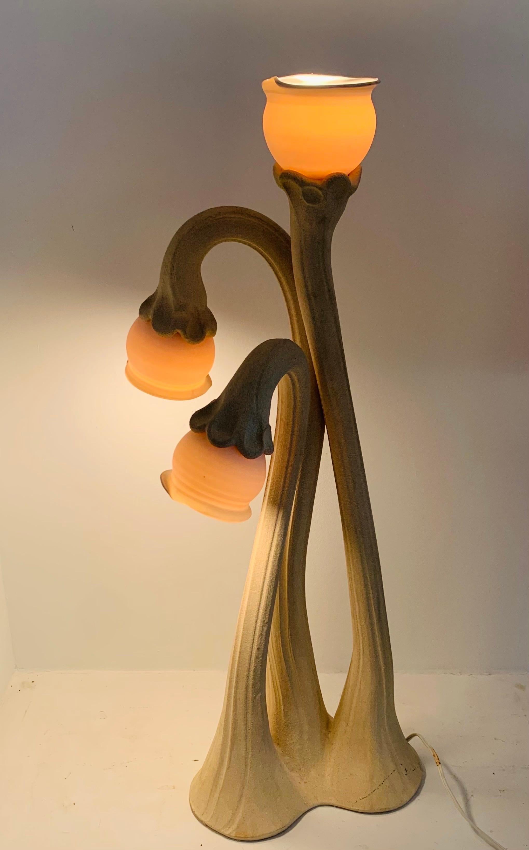 A rare 3-stem handmade Calla Lilly lamp by Doug Blum, circa 1980.

Standing 32” Tall 

Doug Blum is best known for wheel thrown stoneware and porcelain lamps, known as Lily Lamps: the bases are stoneware, the lamp globes are a translucent porcelain