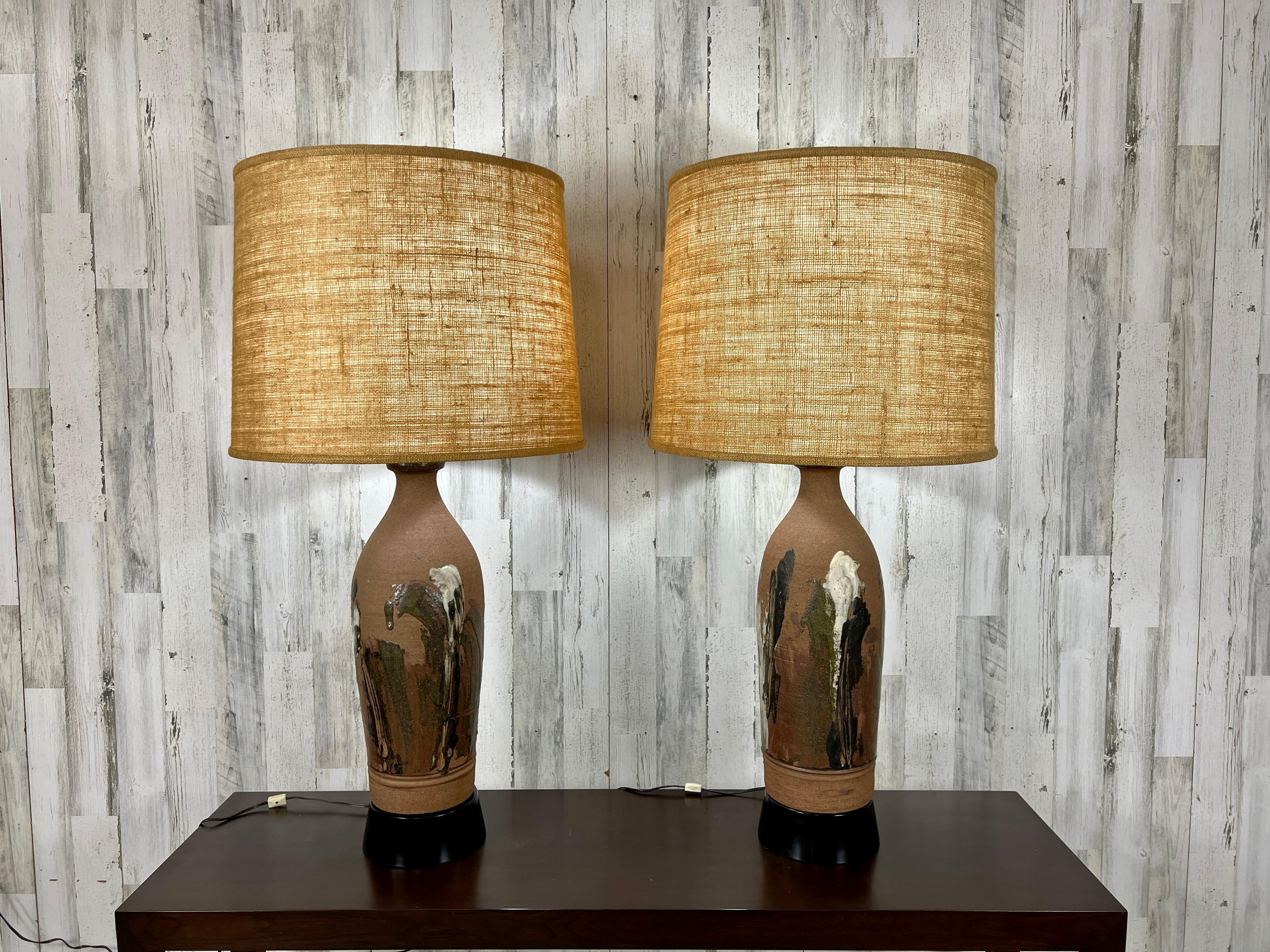 Studio crafted stoneware vase shape with classic earth tone glaze by Larry Shep for Marbro lighting . The painted wood base and dual bulb fixture for maximum lighting. The lamps without the shade measures 8