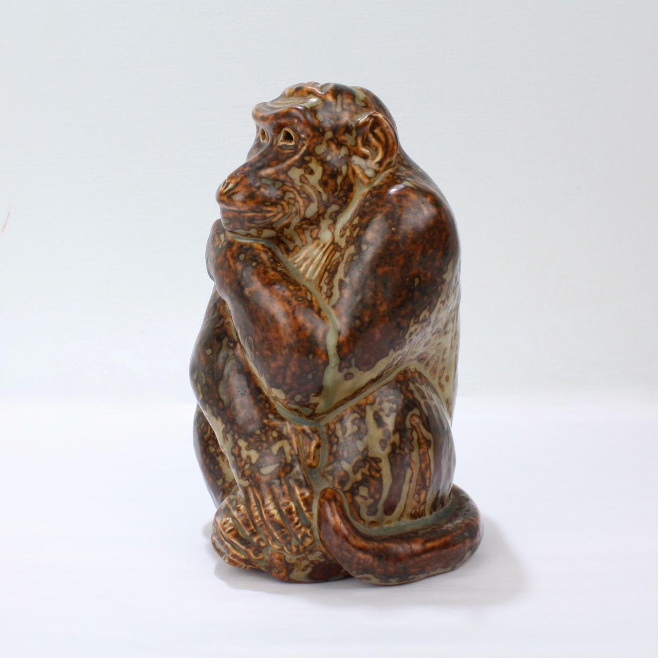 A wonderful stoneware pottery model of a Monkey designed by Knud Khyn for Royal Copenhagen.

Knud Khyn (1880-1969) was a Danish sculptor and painter. He was an important, long-term collaborator with Royal Copenhagen, designing some of the