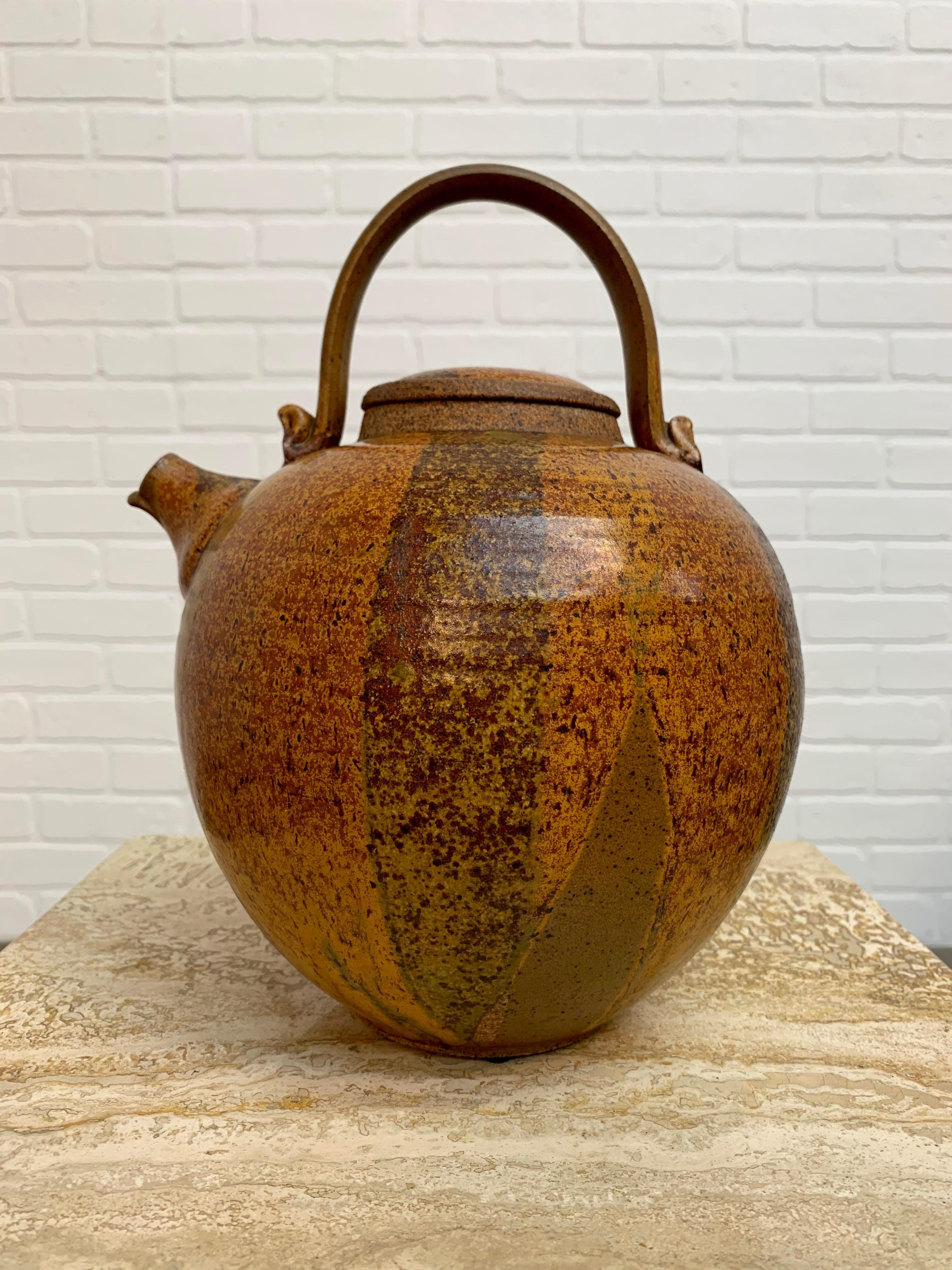 California art pottery watering vessel with lid.