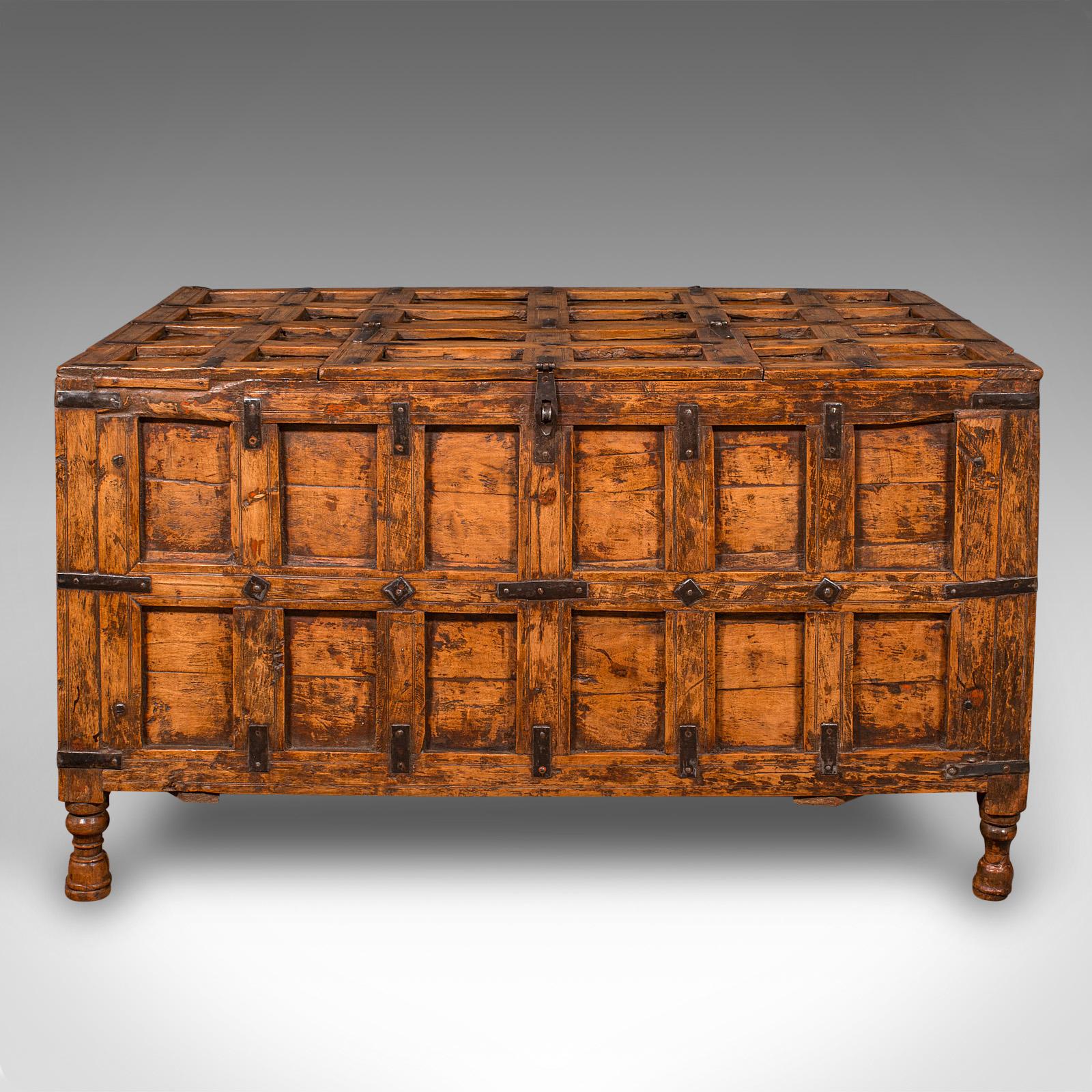 This is a vintage silver chest. An Indian, stained pine storage trunk or occasional coffee table in Colonial revival taste, dating to the late 20th century, circa 1970.

A fascinating Pithara chest with distinctive bound panel design and expressive