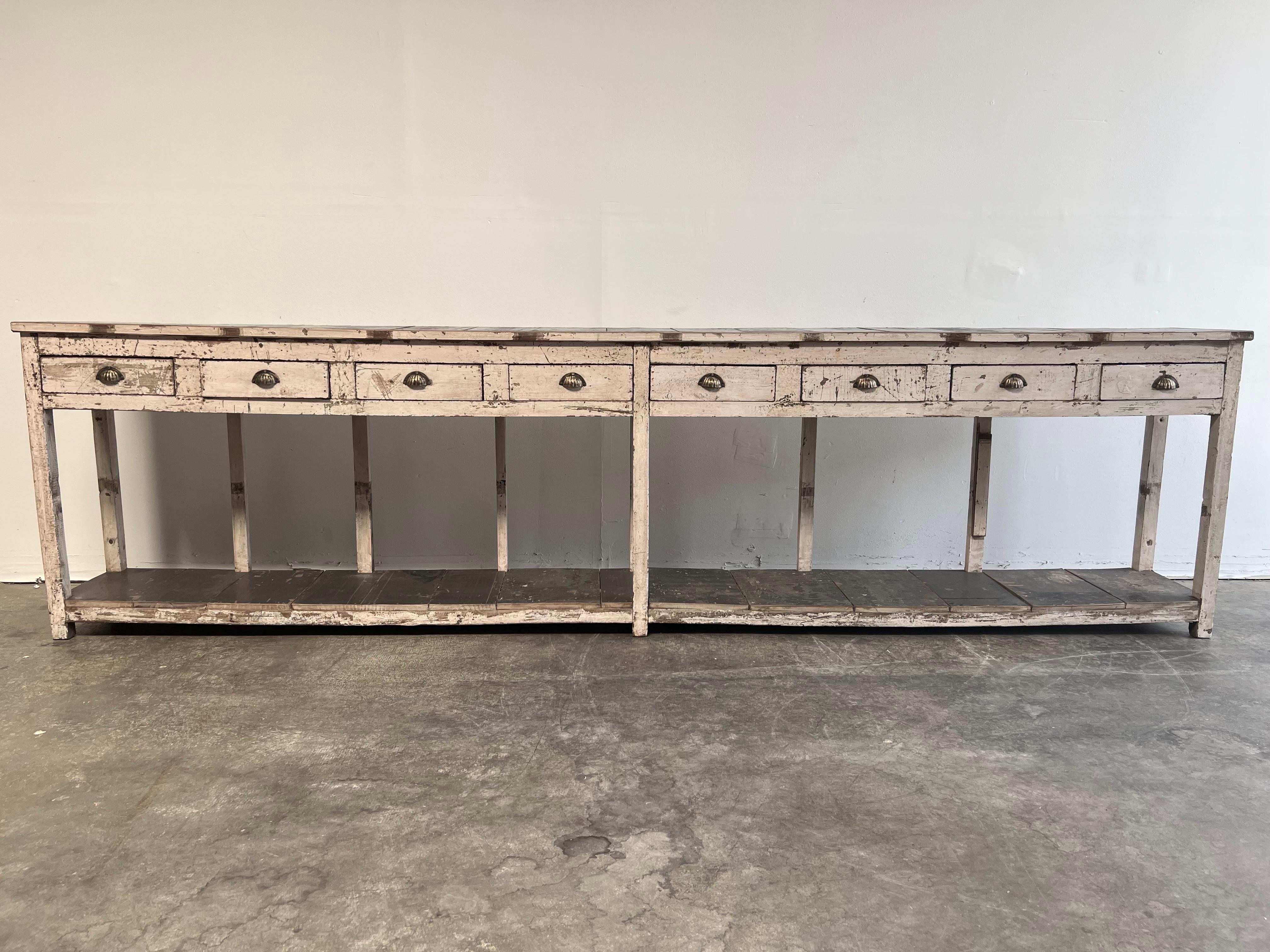 Vintage store counter with drawers, original black and white paint.
Working drawers, narrow depth, very solid and sturdy.
Perfect for a back counter for a store, or retail space, or use as a console for a living room.
Size: 33.5 H x 127.5 W x