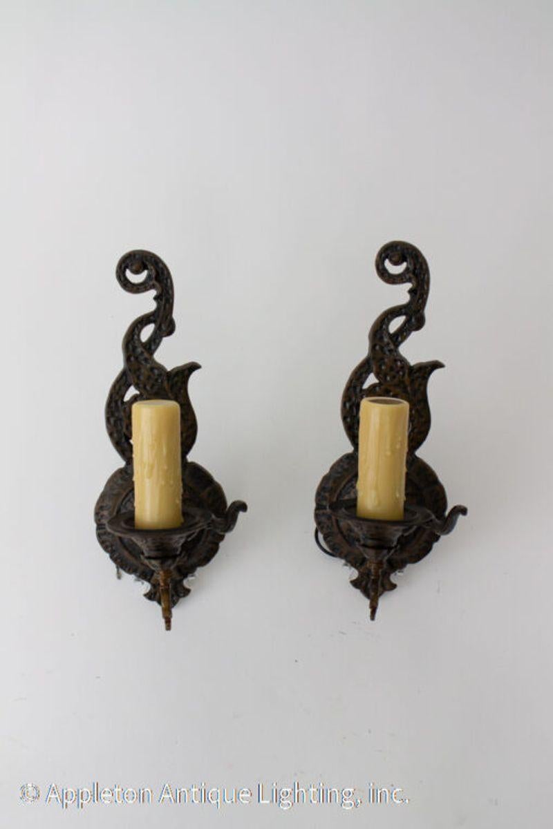 Cast iron vintage storybook sconces with a bronzed finish by Halcolite of Brooklyn, NY. Backplate of sconces is made to look like entwined branches and has a switch. C. 1920 These sconces would be at home in a Tudor, Spanish Colonial or Arts and