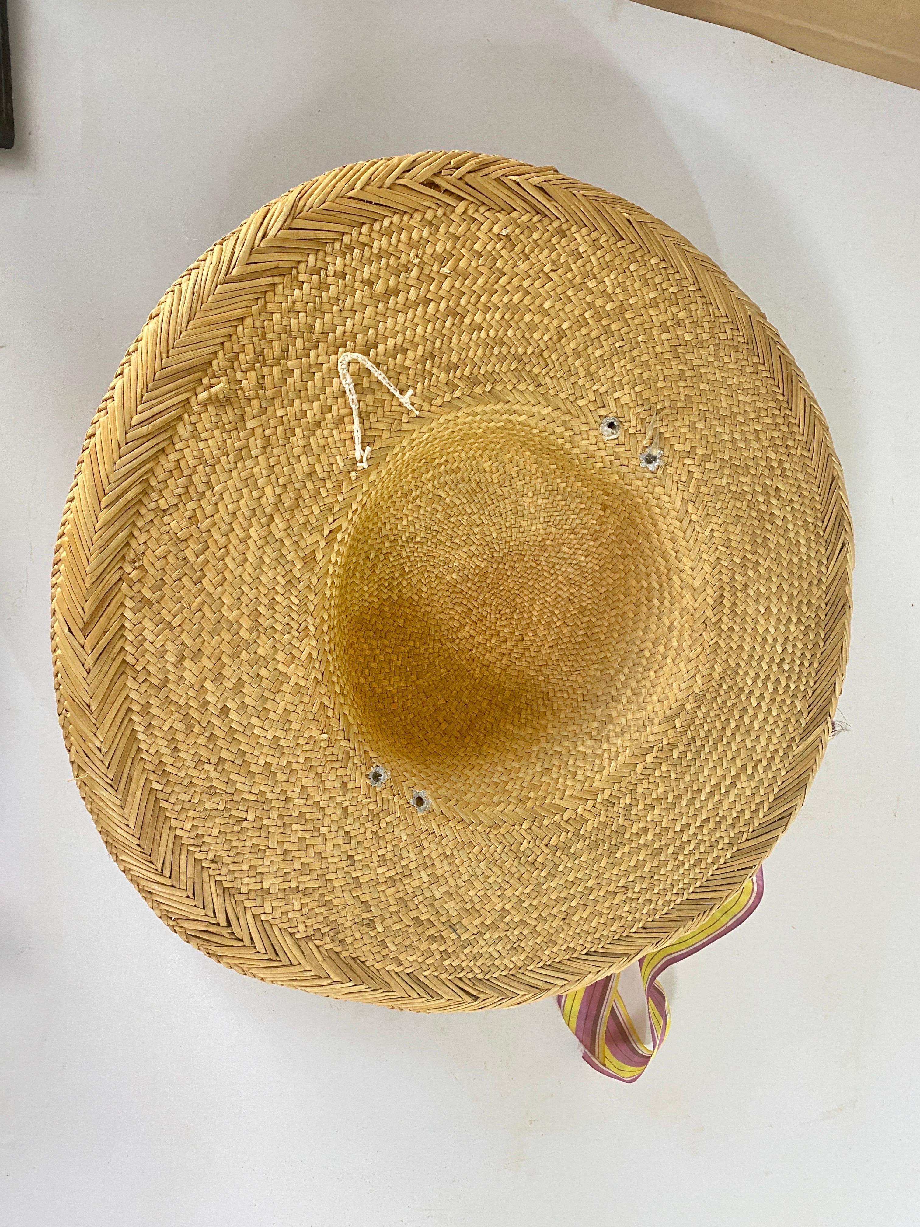 A pretty hat for summer. This vintage straw hat has a brown ribbon 