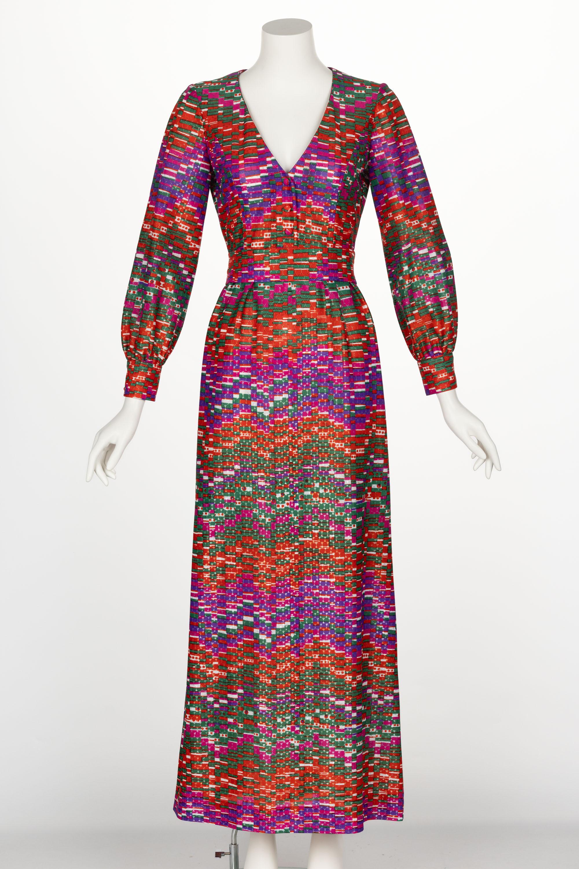 The designer of this dress is unknown, but that makes it no less captivating. Done in a synthetic metallic knit, this beautiful maxi dress hits all the right notes. The dress features an abstract print in shades of purple, white, orange, pink, and