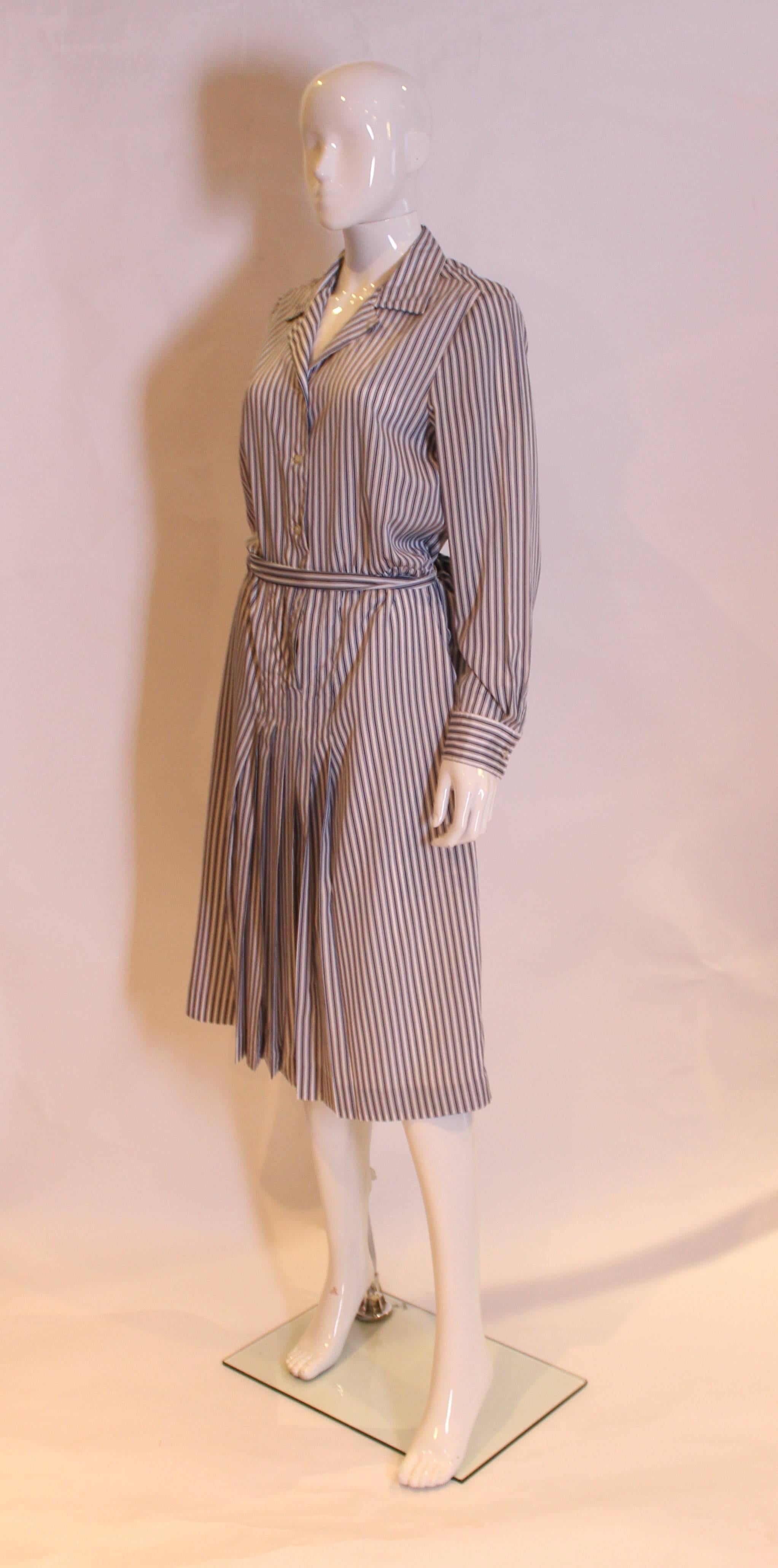 A great dress for Summer by French designer J Tiktiner. In a pinstripe , this   vintage dress has a button front and cuffs, self fabric belt and lined skirt.