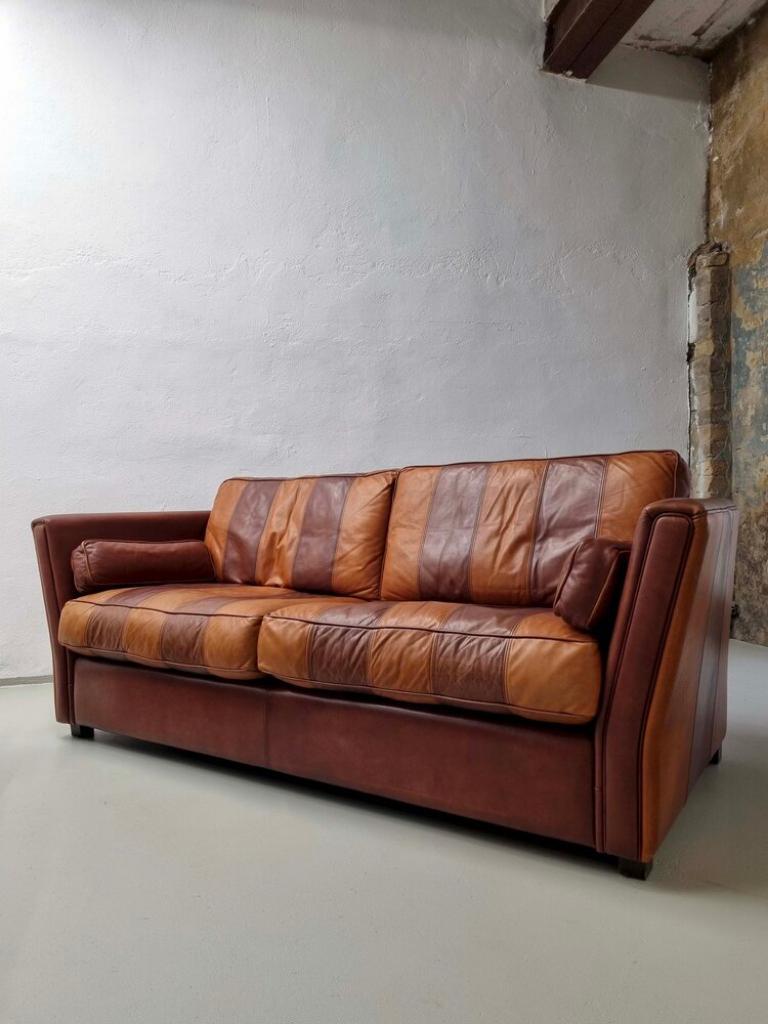 Vintage striped sofa made of high-quality buffalo leather. A statement piece with a matching striped design back. 

Additional information:
Dimensions: 210  W x 88 D x 70 H cm
Seat:  172 W x 43 H cm
Back: 188 W cm