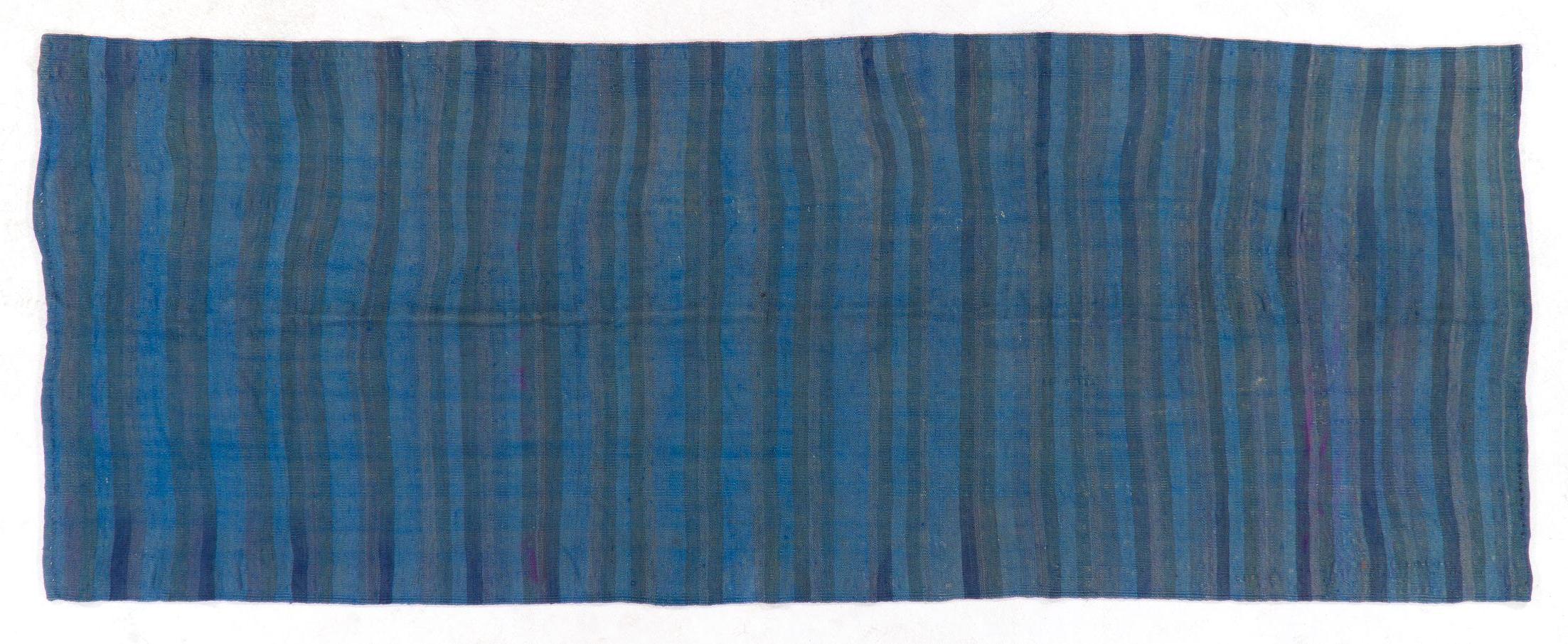 A vintage Turkish flat-woven runner rug made of wool, with a banded design over-dyed in blue.

We can modify the dimensions if requested, ie. make it shorter and/or narrower. 

Reversible; both sides can bu used.

Ideal for both residential and