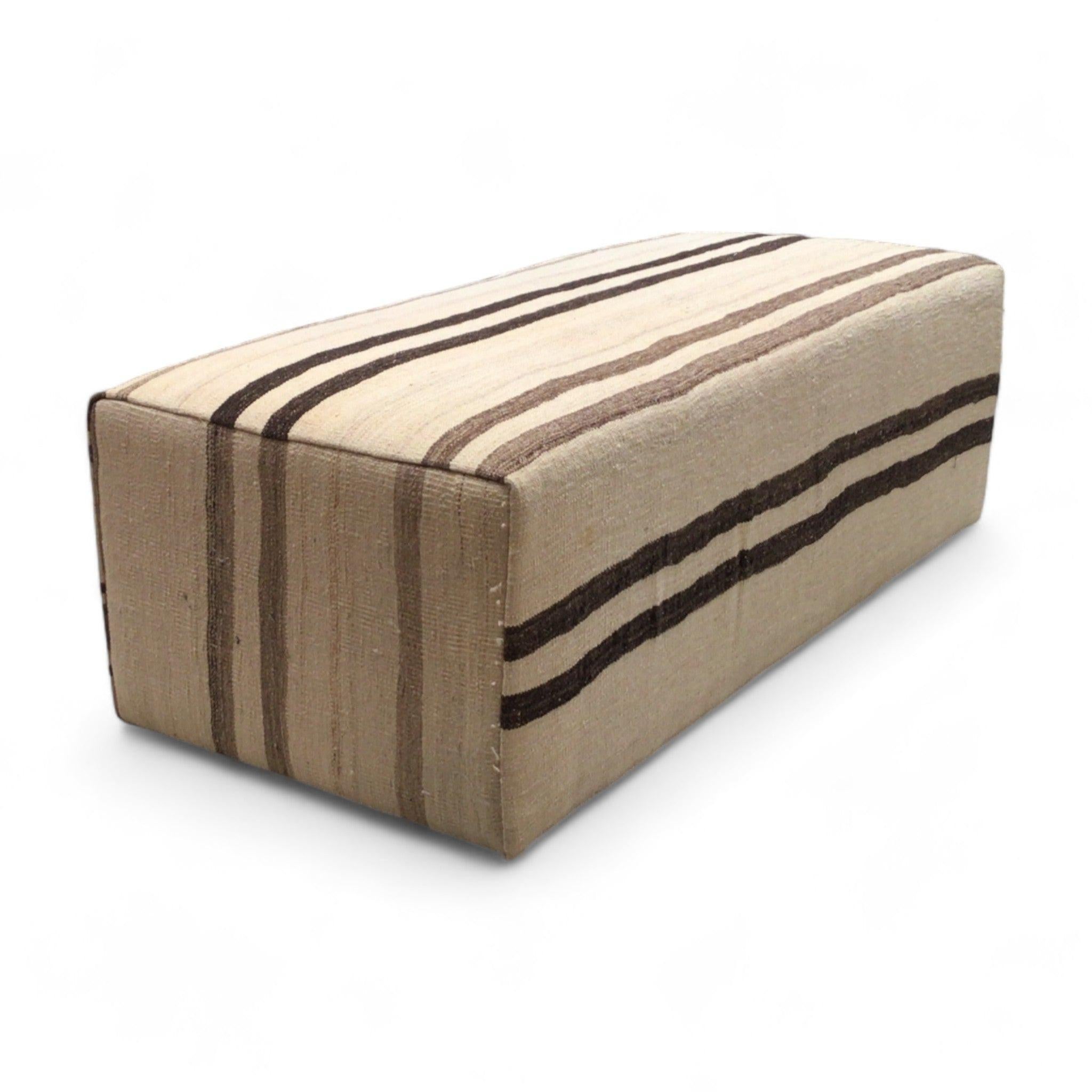 Rich striped ottoman was newly made with a deconstructed vintage rug. The grandiose scale makes a great statement in a room and is a unique option for a coffee table. Perfect addition to a cosy, liveable space.