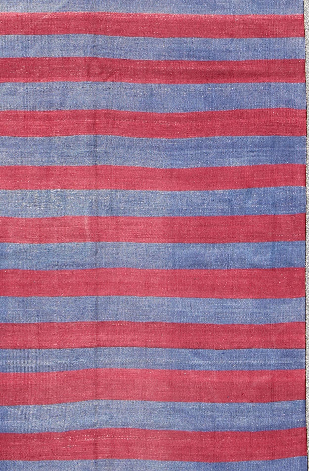 Red and blue Vintage striped Turkish Kilim suited for modern casual interiors. Kilim rug with stripes, Keivan Woven Arts / rug/ EN-165696, country of origin / type: turkey / Kilim, circa mid-20th century. 
Featuring a repeating horizontal stripe