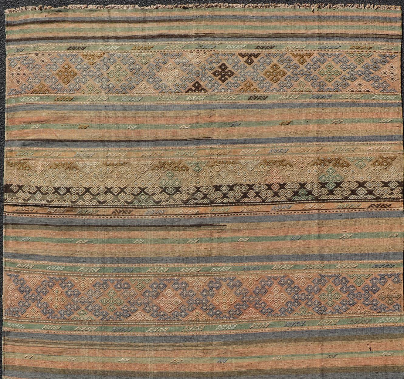 Vintage Turkish Kilim rug with geometric shapes and colorful stripes, rug TU-NED-1038, country of origin / type: turkey / Kilim, circa mid-20th century

Measures:5'7 x 10'

Featuring geometric shapes rendered in a repeating horizontal stripe