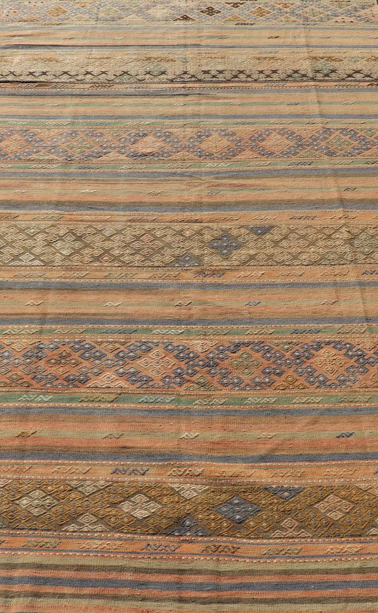 Gestreifter türkischer Kelim-Teppich mit geometrischen Formen und weichen, gedämpften Farben im Angebot 1