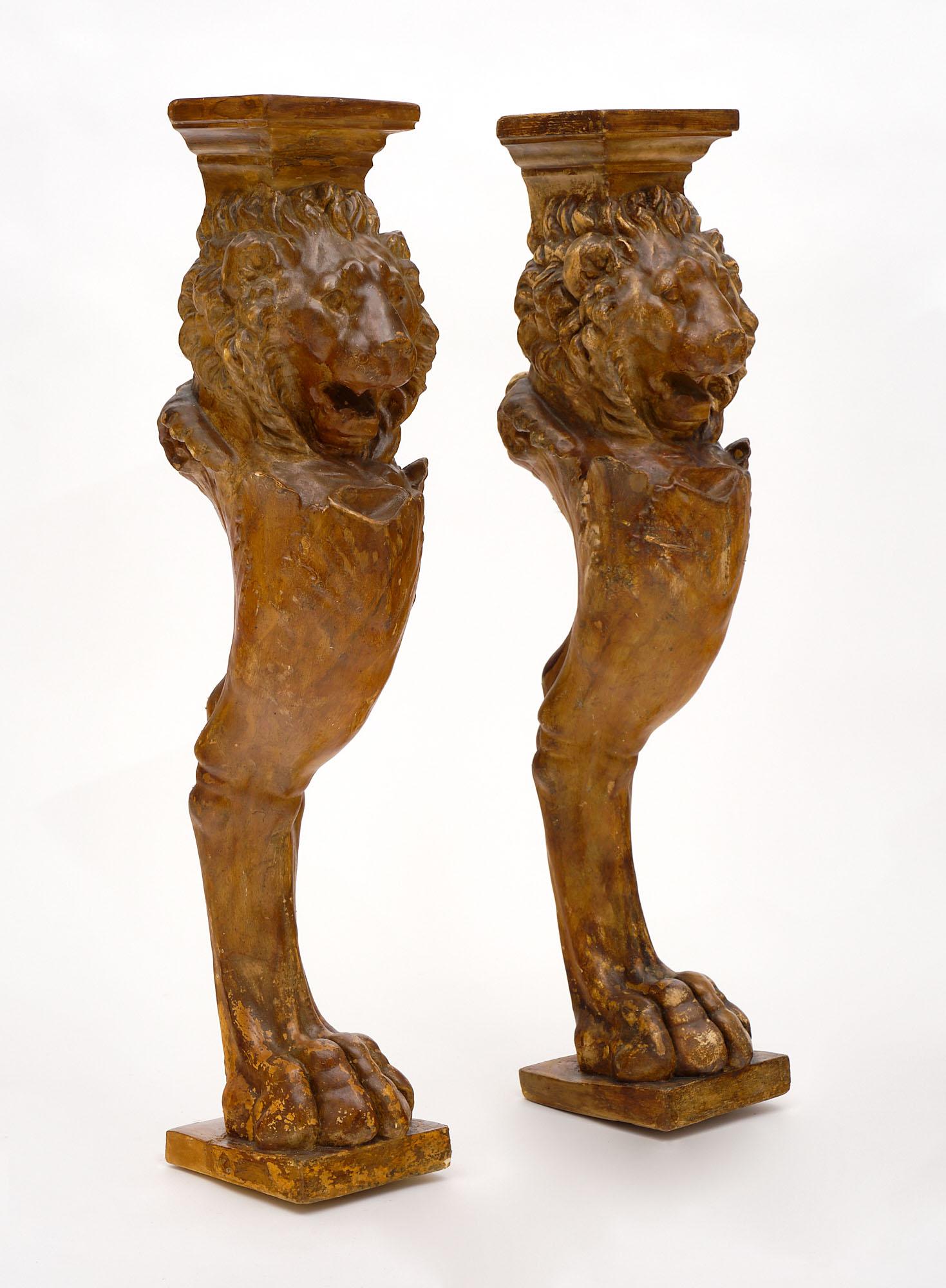 Pair of stucco lion pillars for a fireplace or console. They have a beautiful terra-cotta patina.