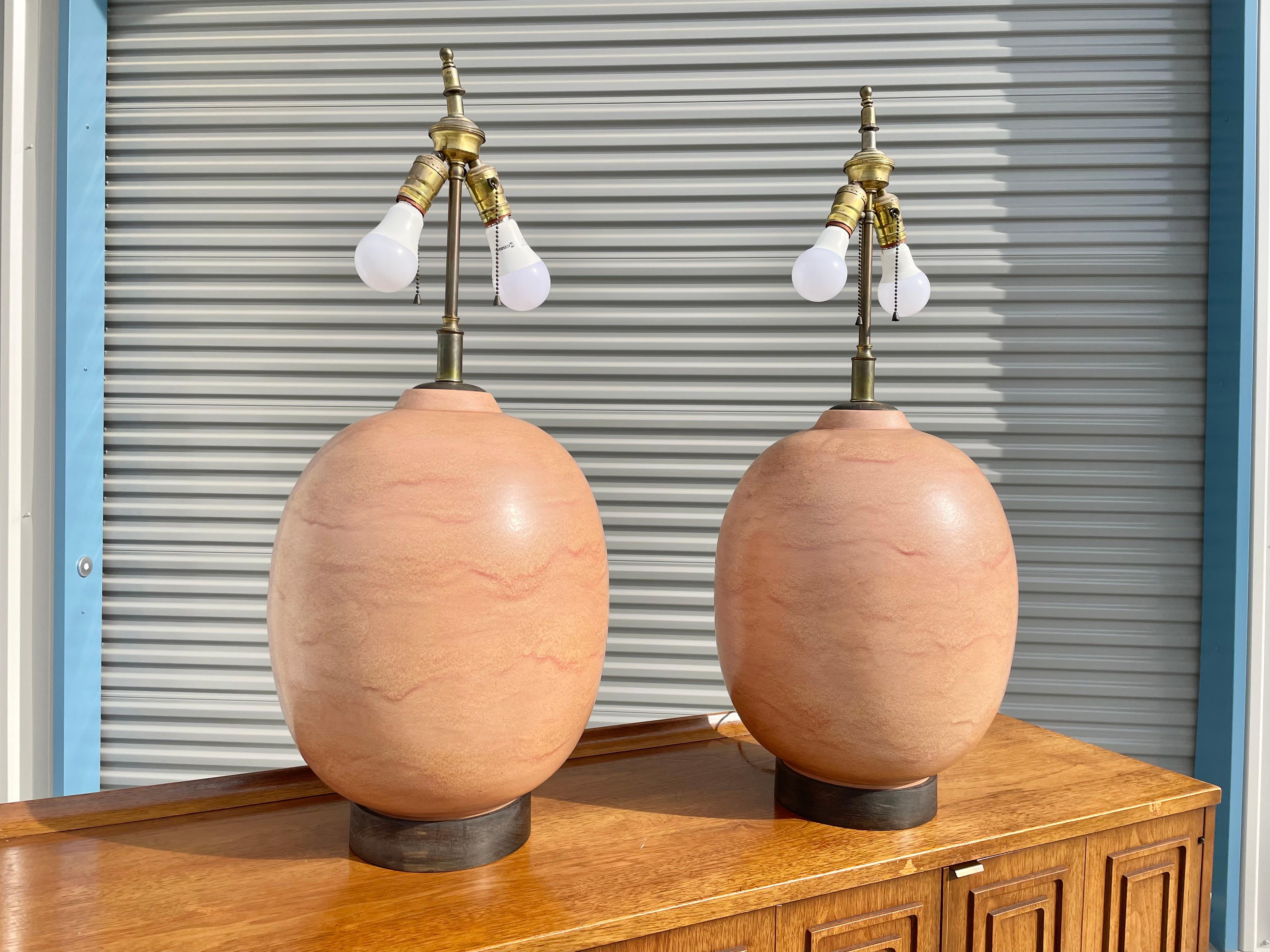 Vintage pair of ceramic lamps designed and manufactured in the United States circa 1970s. These beautiful lamps have a fantastic ceramic egg shape design with beautifully glazed finished. You can tell that the designer put all his heart into this