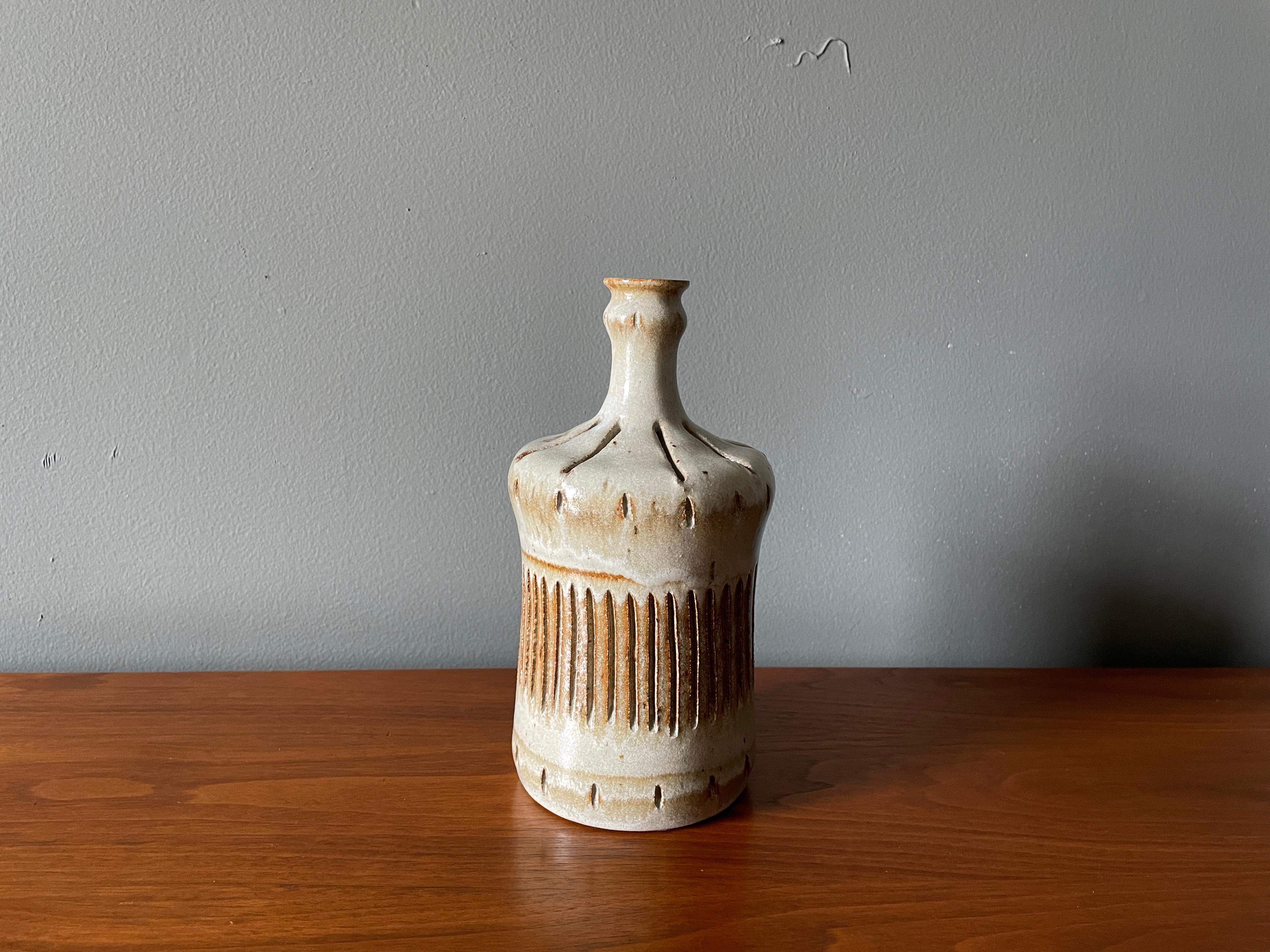 Vintage studio crafted ceramic vase. Signed and dated 1982. Clean, simple design with a beautiful glazing and composition.