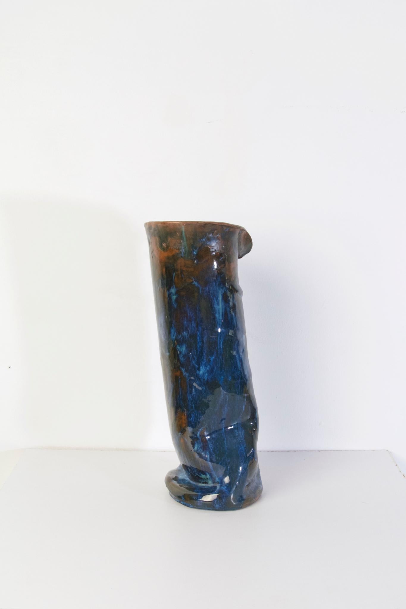 A large studio handmade ceramic vase in blue and brown glaze. Marked underneath with the initials A.M. 1969.