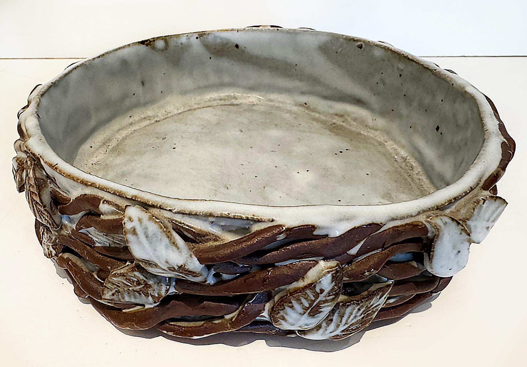 Vintage Studio Pottery Catchall Bowl with Twigs and Leaves

Offered for sale is hand-built studio pottery catchall bowl decorated with a woven arrangement of twigs and leaves. The piece is rustically crafted In brown and mottled off-white/grey
