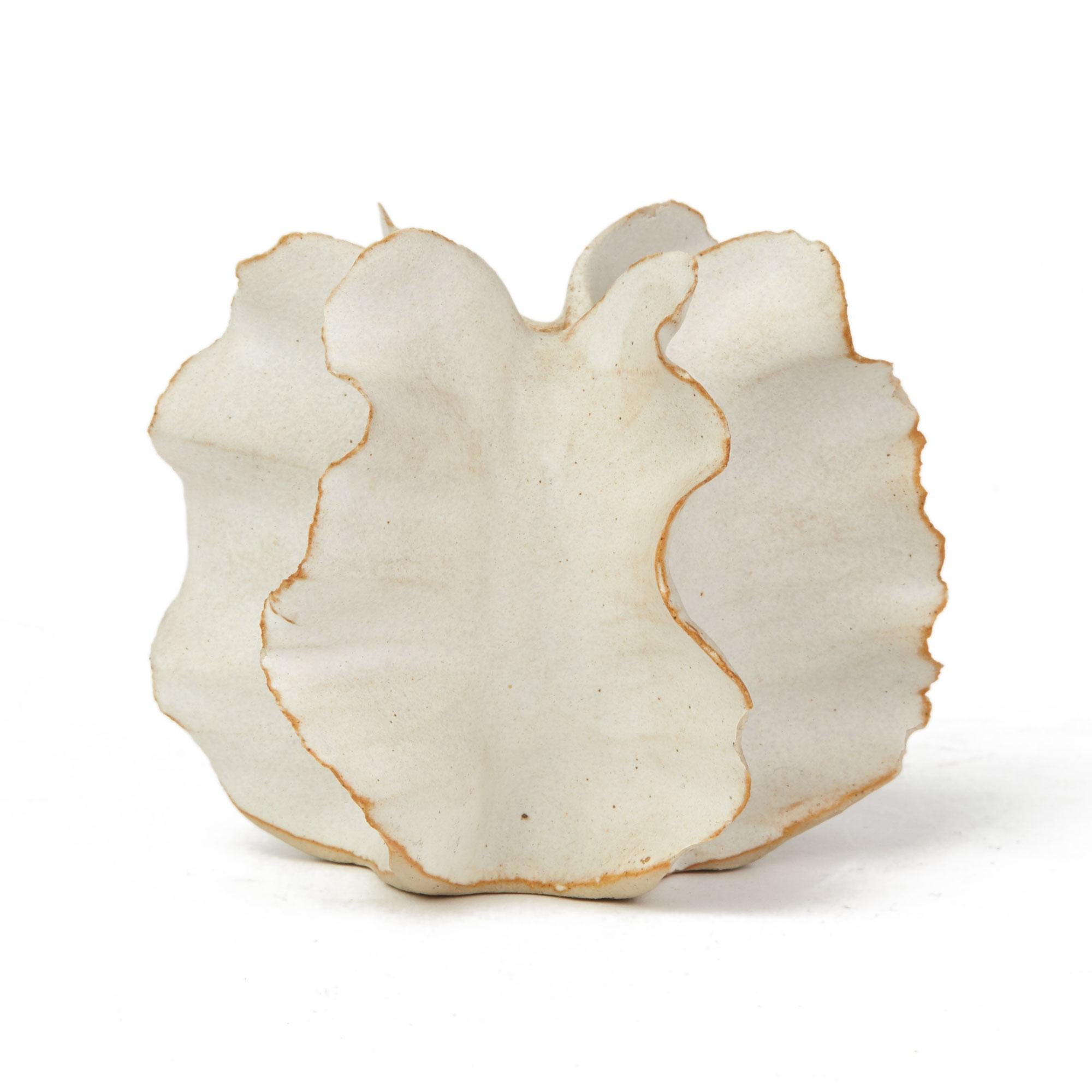 A stylish sea urchin shaped Studio Pottery vase by Sheila & John Francis and made on the Isle of Wight at the Chessell Pottery. The stoneware vase has a small central vase section with six randomly shaped 'wings' molded around the central body. The