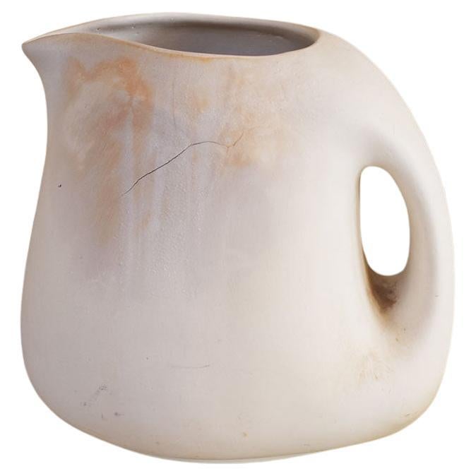 A pretty piece of studio pottery. Unglazed and unpainted, this pitcher is created from clay and has no signature. It would be a beautiful piece for display on a shelf or table. 

Dimensions:
7.75