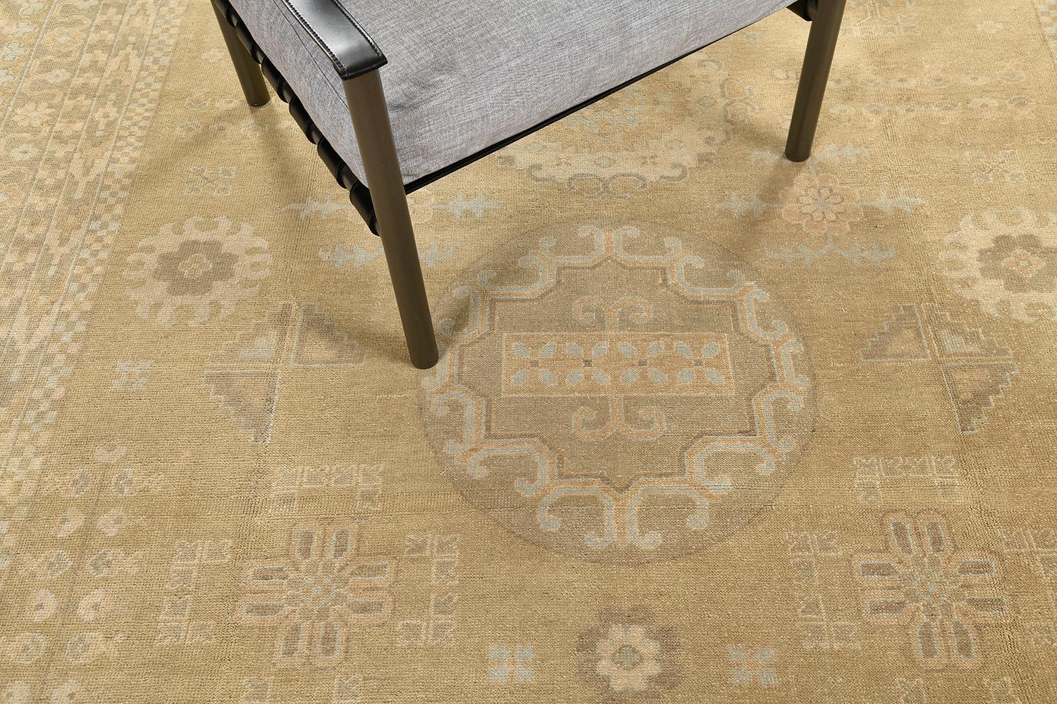 An impressive hand-spun wool Khotan design revival from our collection has come and flexed its versatility. This rug is flexible for any home interior decor. Stylized motifs and grandiose medallions over a camel field and ivory outline manifest the