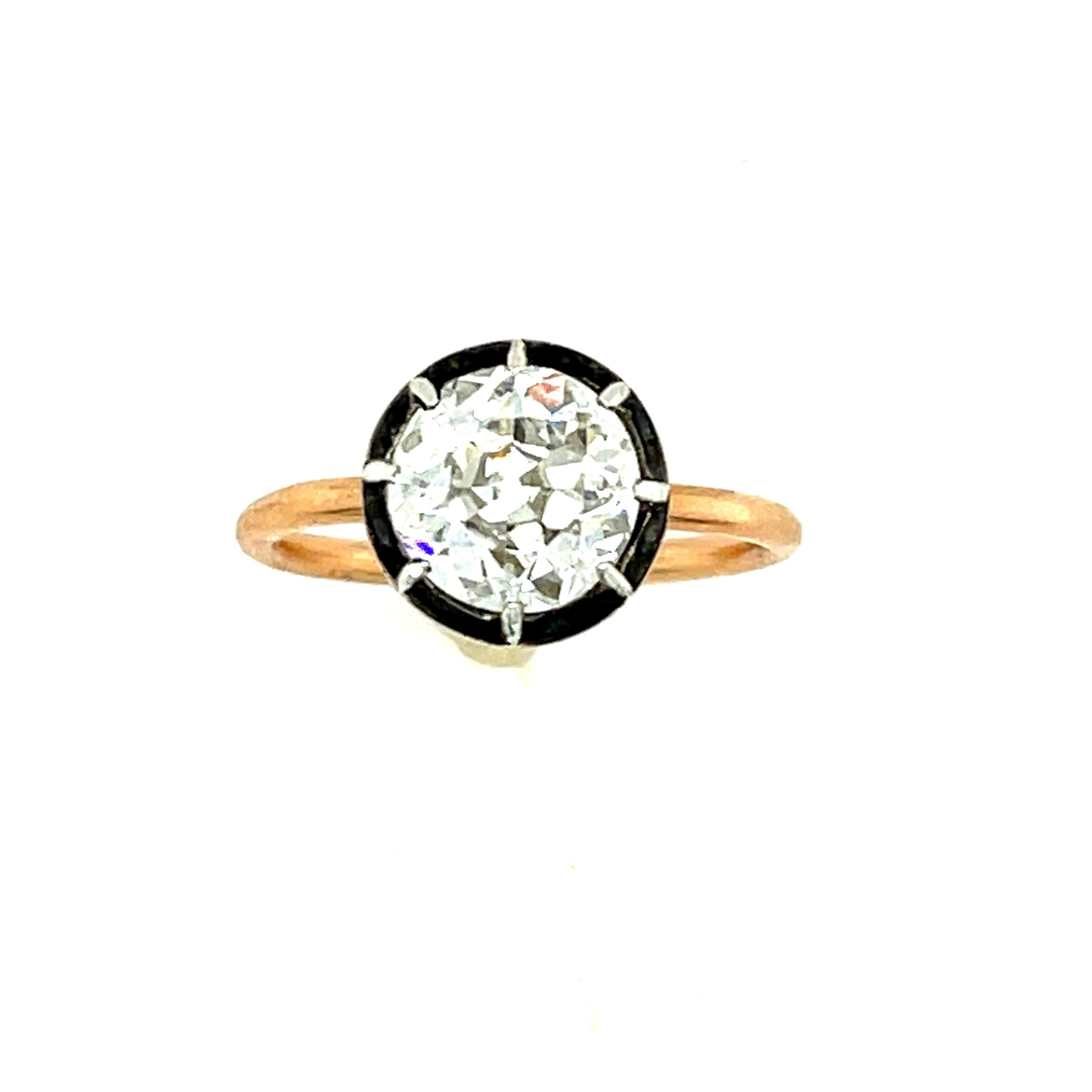 Collet set Old European Cut diamond weighing 1.68 carats set in a blackened gold bezel and 18k rose gold shank. A mix of contemporary and antique, this is a charming ring. The diamond is a beautiful warmer color diamond that faces up white. We