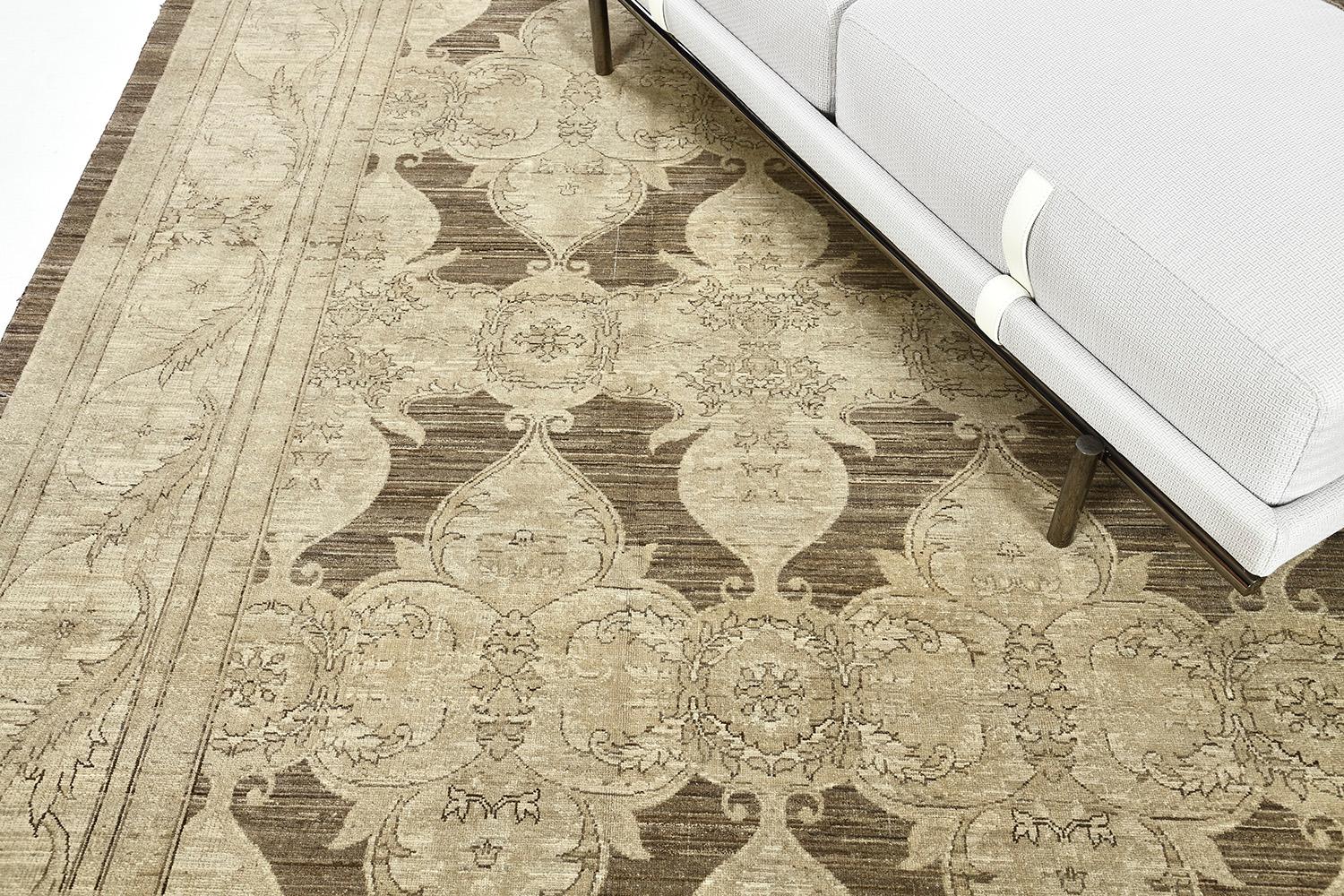 An astounding revival of Arts & Crafts style rug that features the elegant tones of a grayscale. Fabricating gracefully in an ash field, the mirrored pattern over an opaque charcoal diamond background. Ornamental embellishments are formed flawlessly
