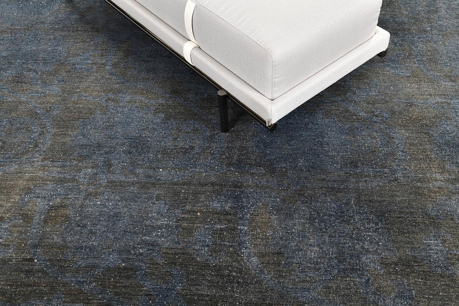 A sweet repetitive in design revival of Arts & Crafts rug makes more stylish than ever. Overdyed color combinations of blue and charcoal in an all-over design. These were regularly used in several connecting spaces. It is perfectly fit for spaces