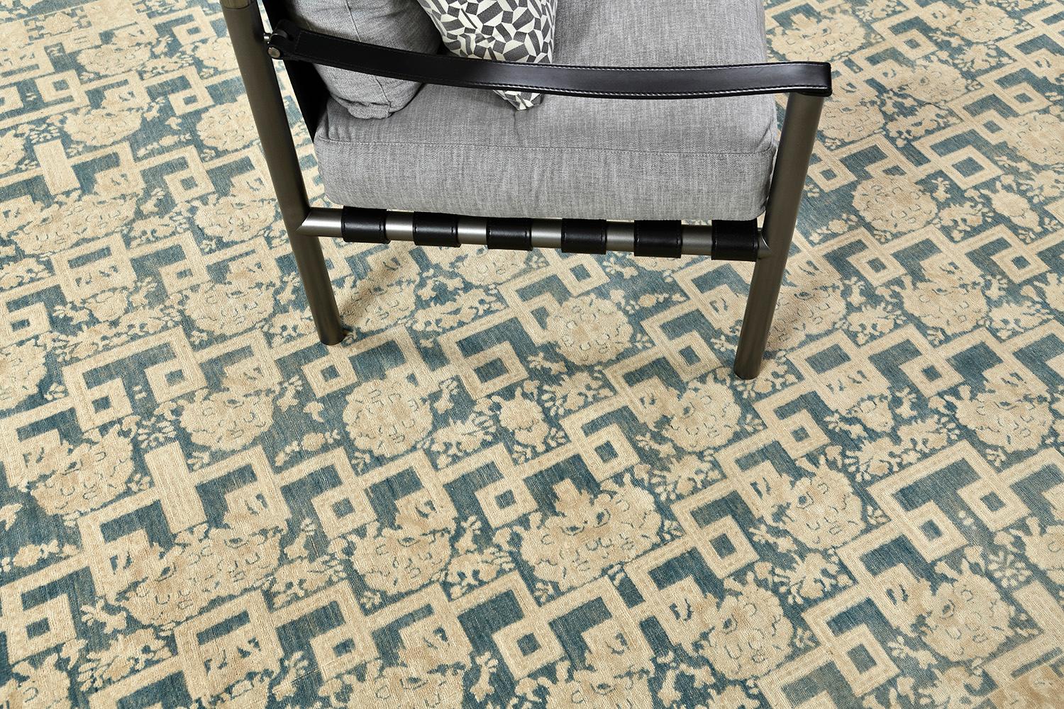 An astounding masterpiece of Arts and Craft Style rug that features the elegant tones of teal and ivory. Fabricating gracefully in an ivory field, the geometrical pattern and ornamental embellishments are formed flawlessly enclosed by a classy