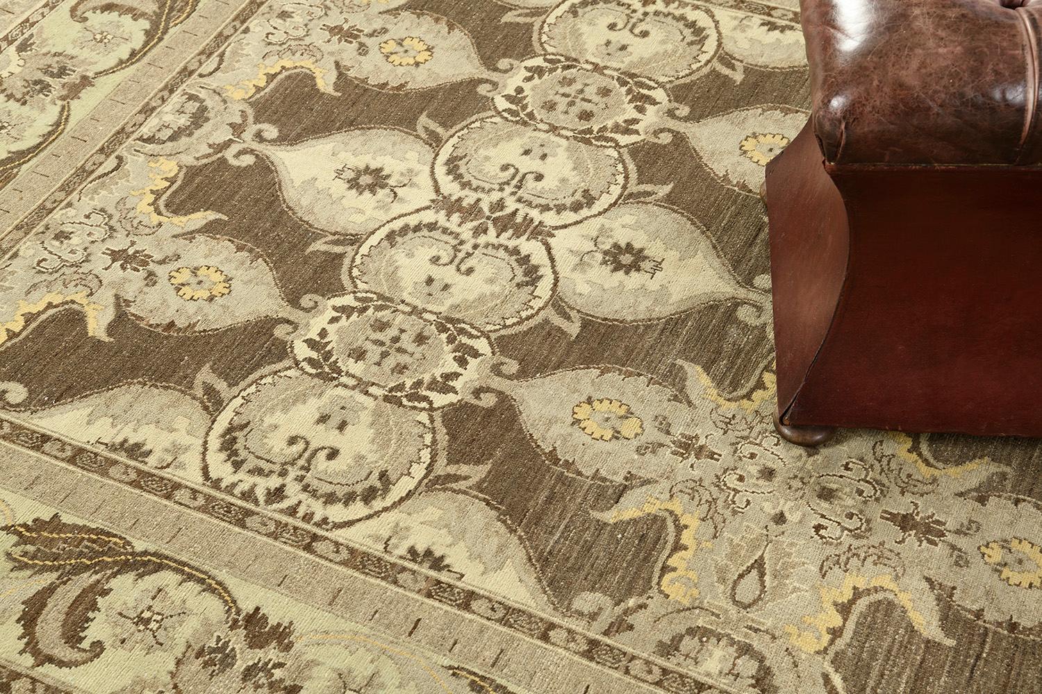 An amazing revival of Arts and Crafts Style rug that features elegant neutral tones. Fabricating gracefully in an opaque brownfield, the mirrored pattern is well-coordinated and matches the theme. Ornamental embellishments are formed flawlessly
