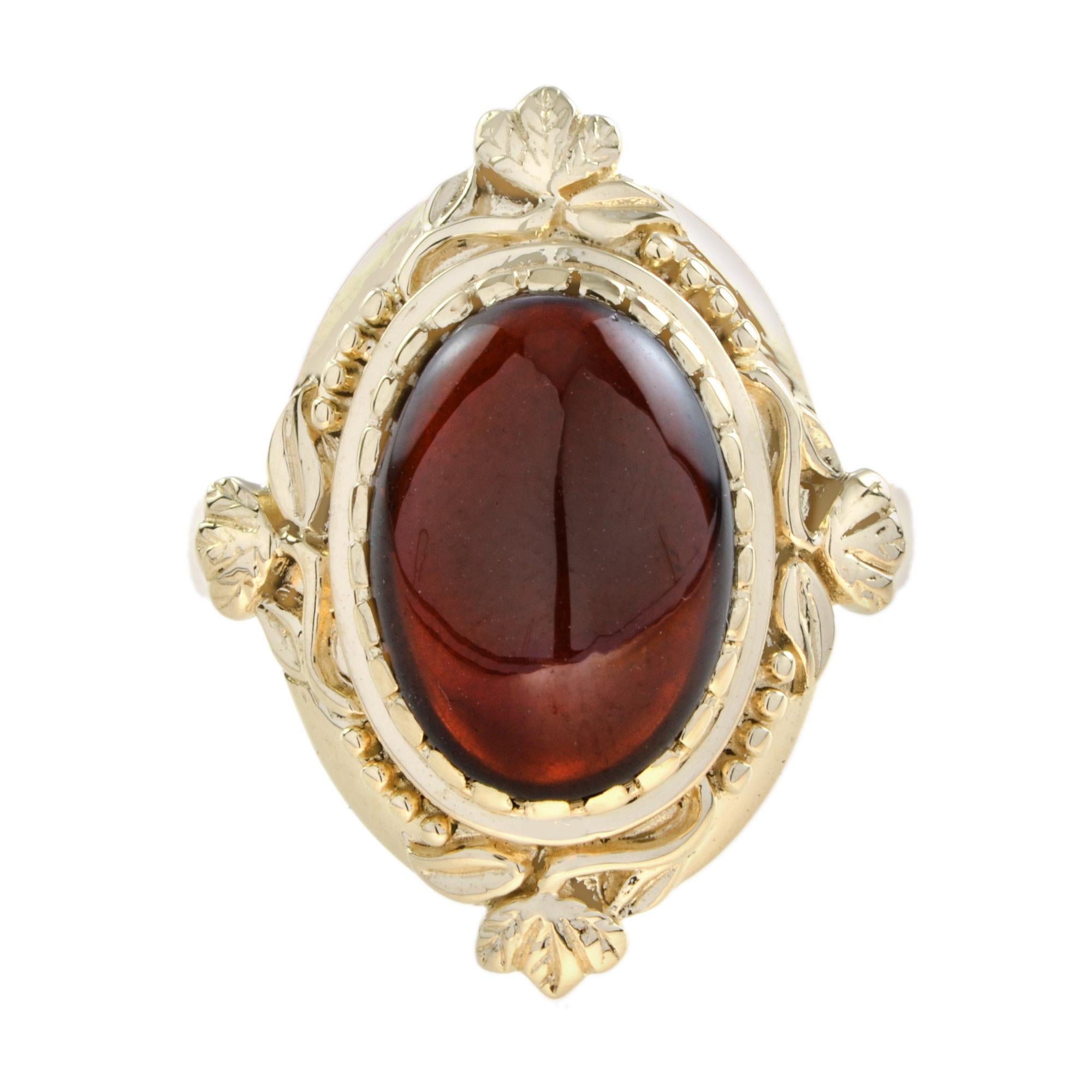 Vintage styling in a yellow gold ring, with very fine twist-wire work and leaf motifs, bezel set with a beautiful wine-red cabochon cut garnet. 

Ring Information
Metal: 9K Yellow Gold
Total weight: 6.59 g. (approx. total weight)
Size: US