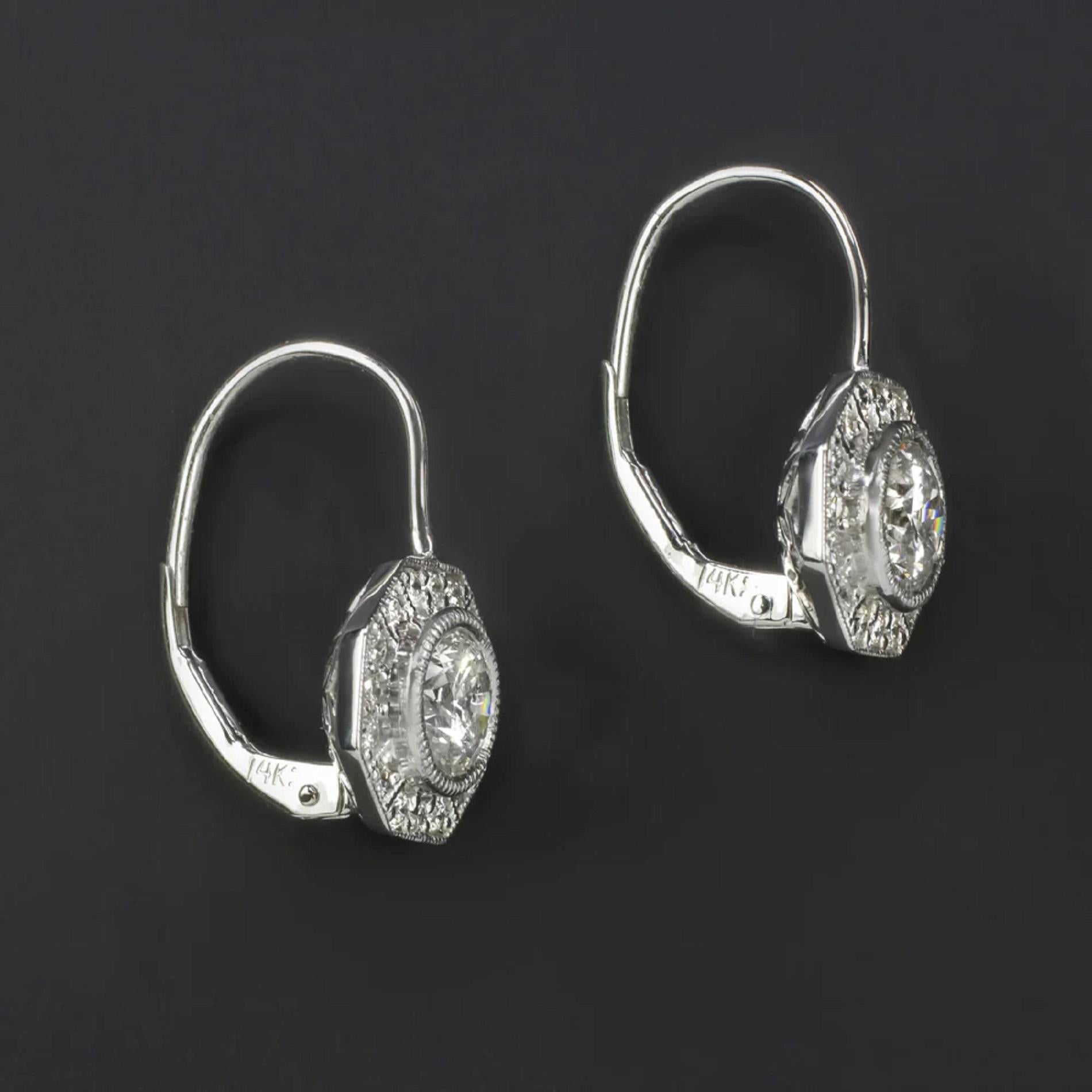 These diamond drop earrings offer an utterly classic look with a 1.54ct pair of diamond surrounded by vintage style octagon shaped halos.

Highlights:

- 1.54ct pair of natural diamond center stones

- Center diamonds are bright white with vibrant
