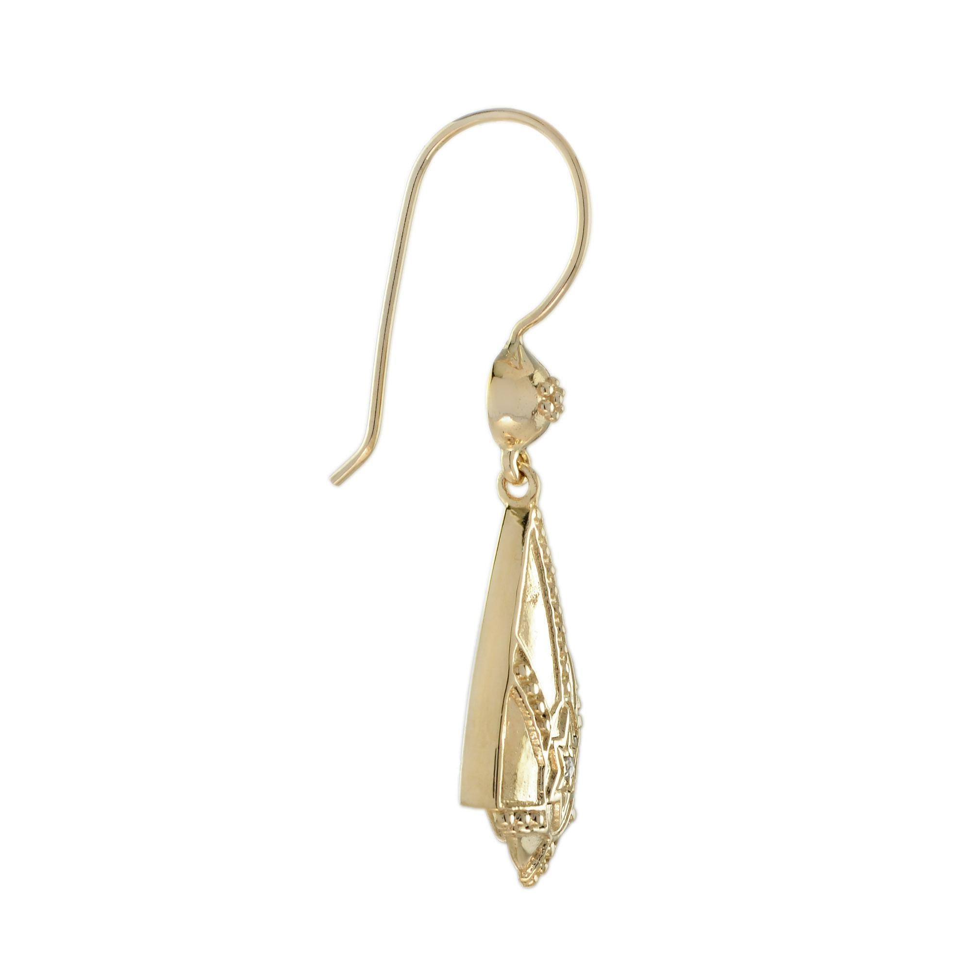 These classic Art Deco inspired diamond earrings are crafted in warm tone of 9k yellow gold. The body of each earring features a geometric design set with small lovely round cut diamond framed in a star motif. These earrings have a unique vintage