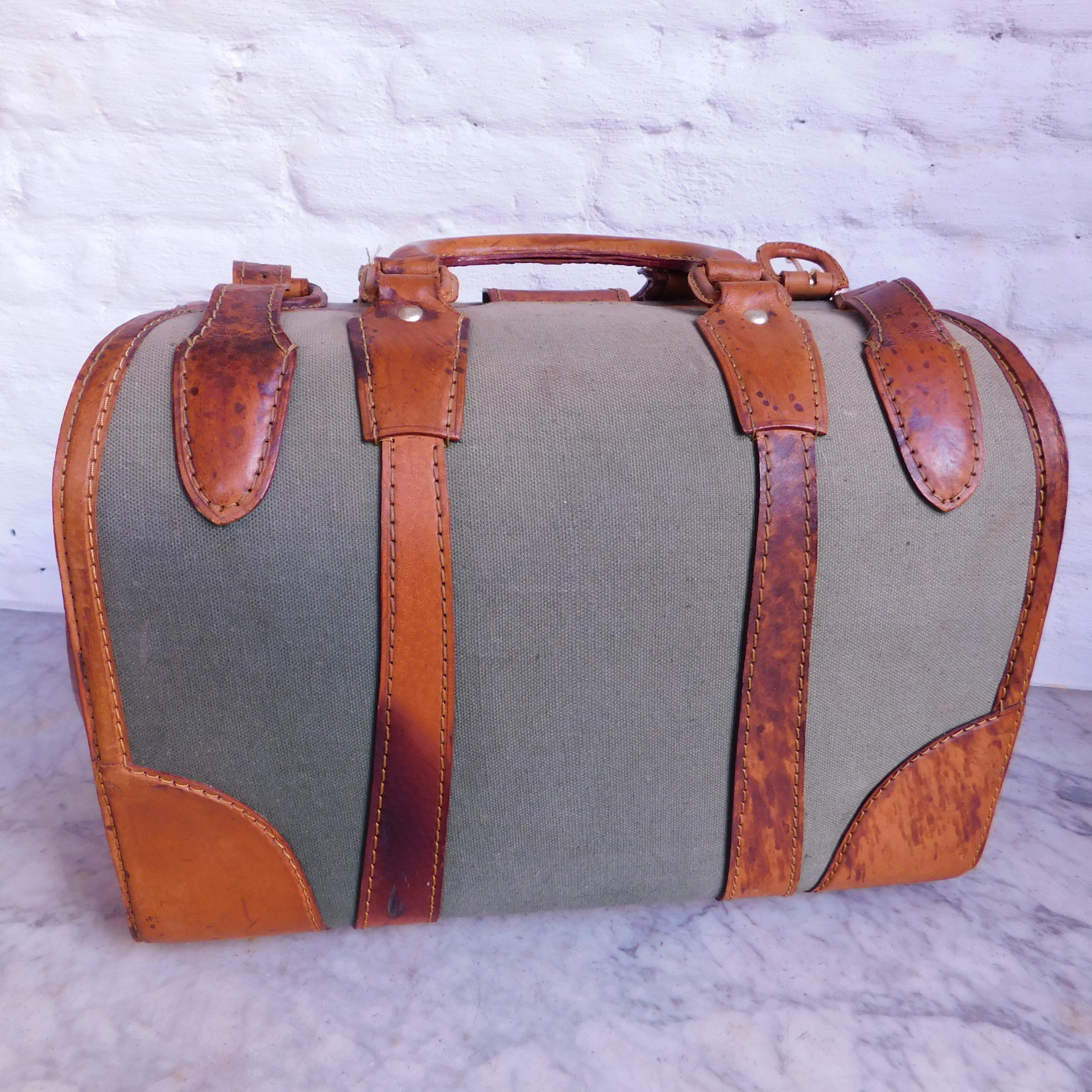 English leather and olive green canvas Gladstone satchel or doctors bag including key.
Great vintage style and very cool to use as a handbag.
 