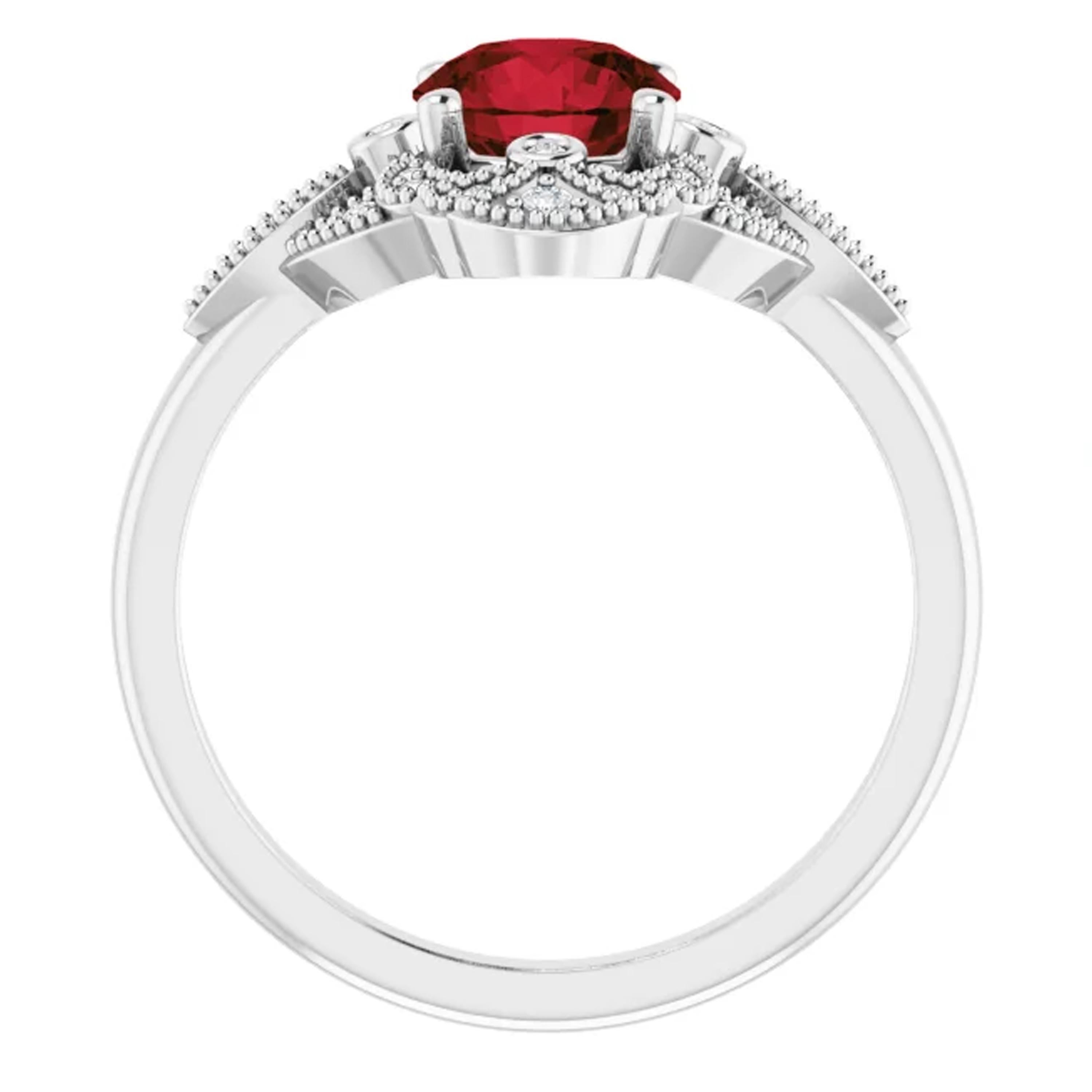 Inspired by the Victorian era; this vintage style bridal wedding ring set is adorned with a halo of shimmering white diamonds. Intricate milgrain detailing surrounds each natural diamond. Showcasing a red garnet 1.02 carat center stone, this wedding