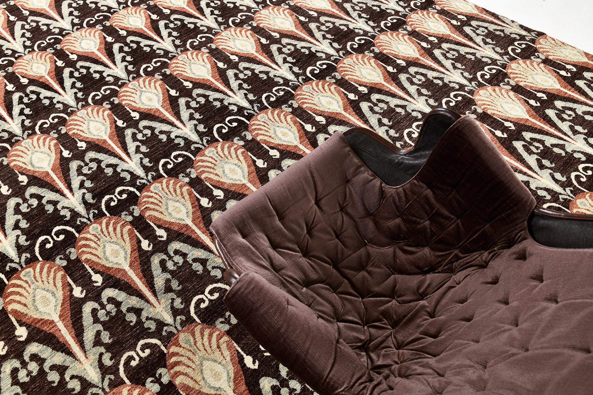 A modern vibrant transitional rug that has a well-balanced symmetry and vitality. This magnificent rug beautifully embodies sultry vibes. The hickory field is covered with a series of vivid repetitive Ikat patterns in the inviting shades of