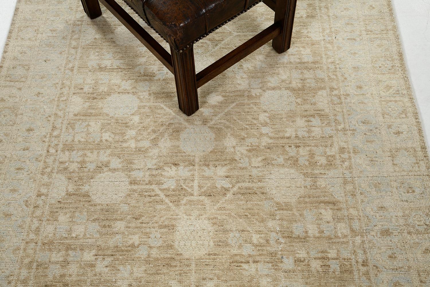 An impressive pile-woven wool Khotan design from our collection has come and flexed its versatility.  Series of medallions and connecting motifs in the muted brown and sky blue theme dominate the entire pattern of the rug. Beautiful floral bands are