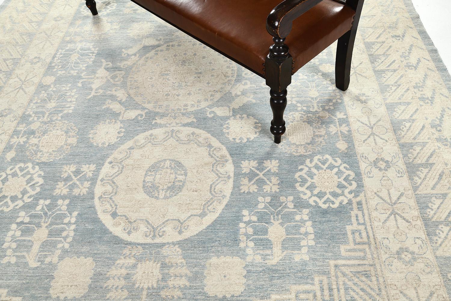 An outstanding pile woven wool Khotan design revival from our collection has come and flexed its versatility. This rug is adaptable for any home interior decor. Stylized motifs and geometrical designs in a muted sands and sky fields manifest the