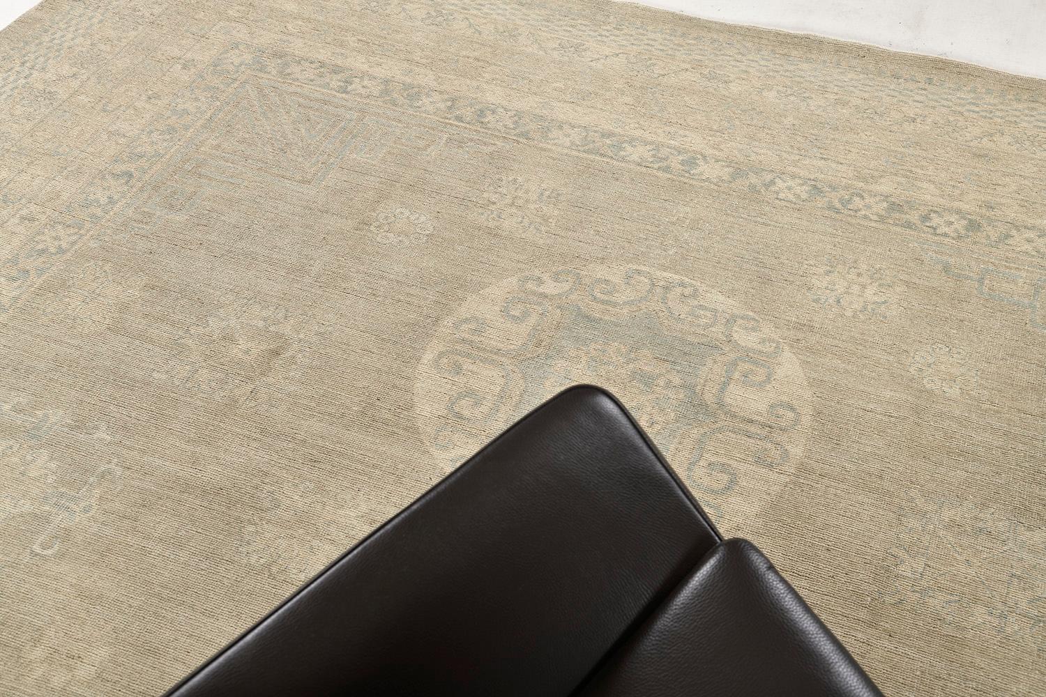 An impressive hand-spun wool Khotan design revival from our collection has come and flexed its versatility. This rug is flexible for any home interior decor. Stylized motifs and grandiose medallions over a camel field and ivory outline in subtle