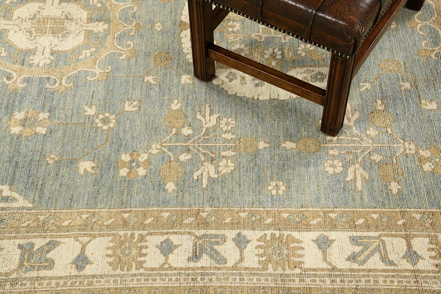An outstanding pile-woven wool Khotan design from our collection has come and flexed its versatility.  Three grandiose medallions and connecting motifs in soft ivory, gold, and blue theme dominate the entire pattern of the rug. Beautiful floral