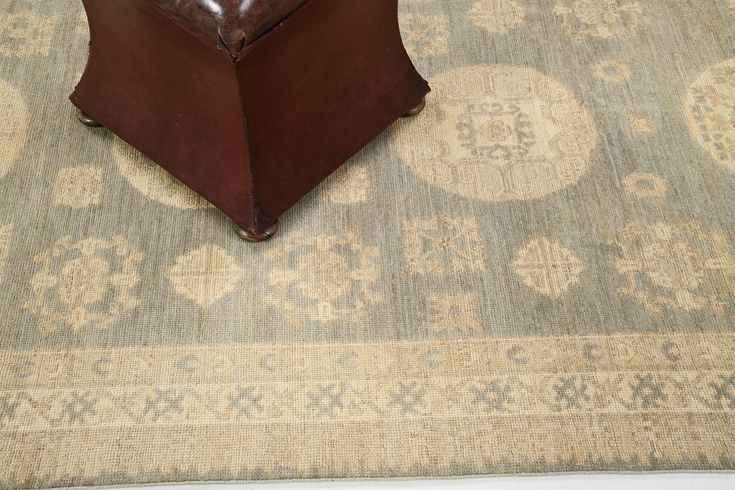 An impressive pile-woven wool Khotan design from our collection has come and flexed its versatility.  Series of medallions and connecting motifs in the muted brown and soft blue theme dominate the entire pattern of the rug. Beautiful floral bands