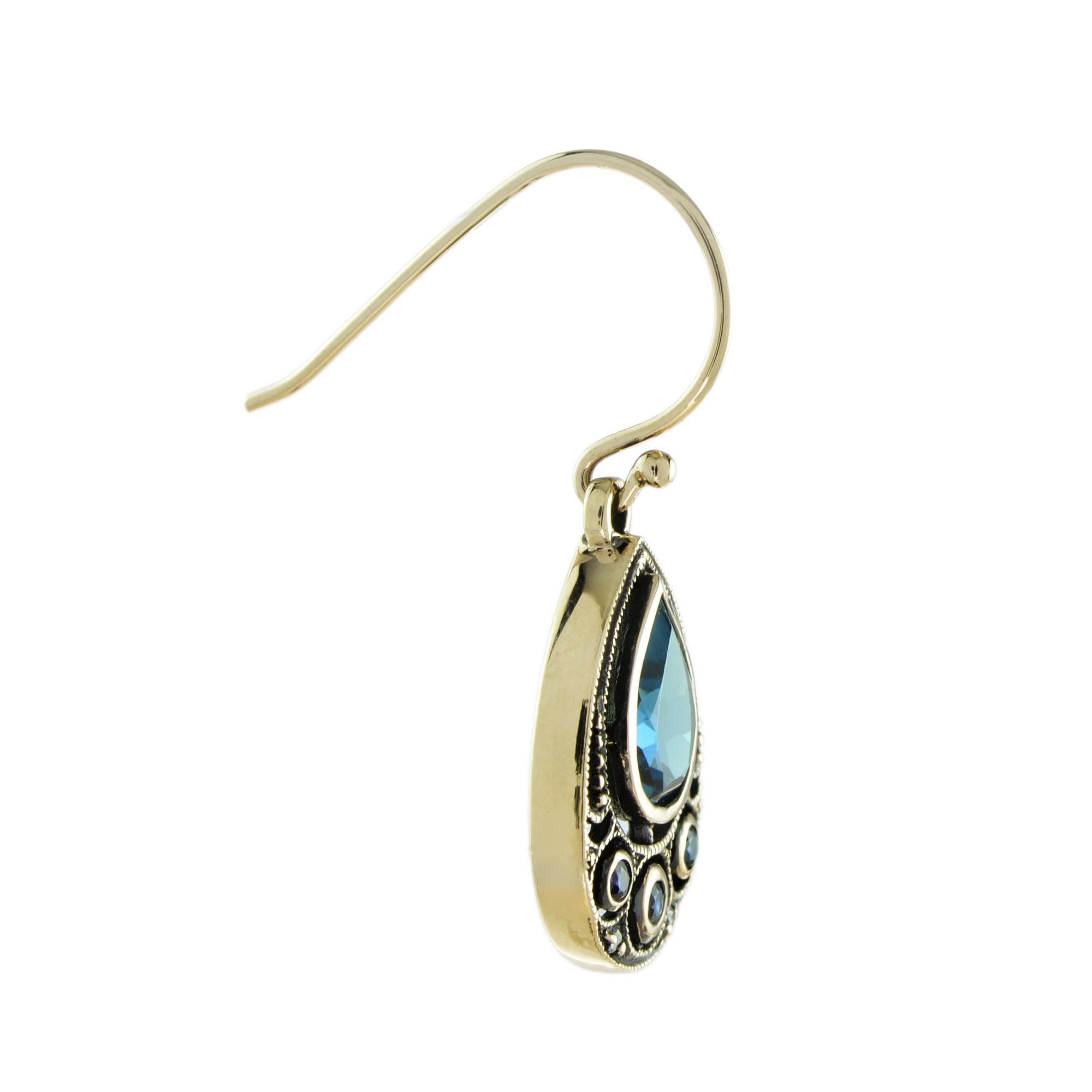 Delightful London blue topaz, sapphire and diamond set earrings add a colorful and vintage-influenced touch to any outfit. The drop shape earrings featured French cut sapphires and round diamond surrounding a drop London blue topaz. These unique