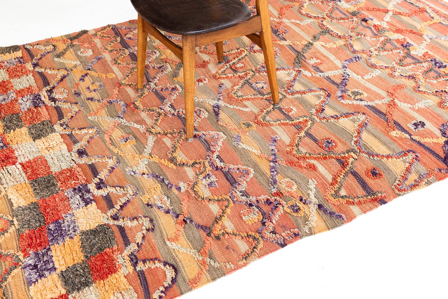 A colorful and lively vintage style Moroccan Kilim. This unique flat-weave is embossed with the perfect colorful wools that create an interesting texture in addition to the rug's symbolic and tribal design elements. This vintage piece will add