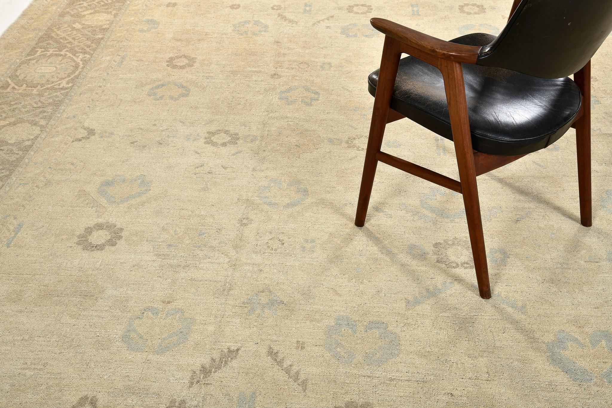 A captivating sandy beige and dusty blue muted revival of Oushak design rug that was made from the finest selection of natural dye and hand spun wool. The rustic character of this breathtaking rug will tone down a formal design scheme and give your