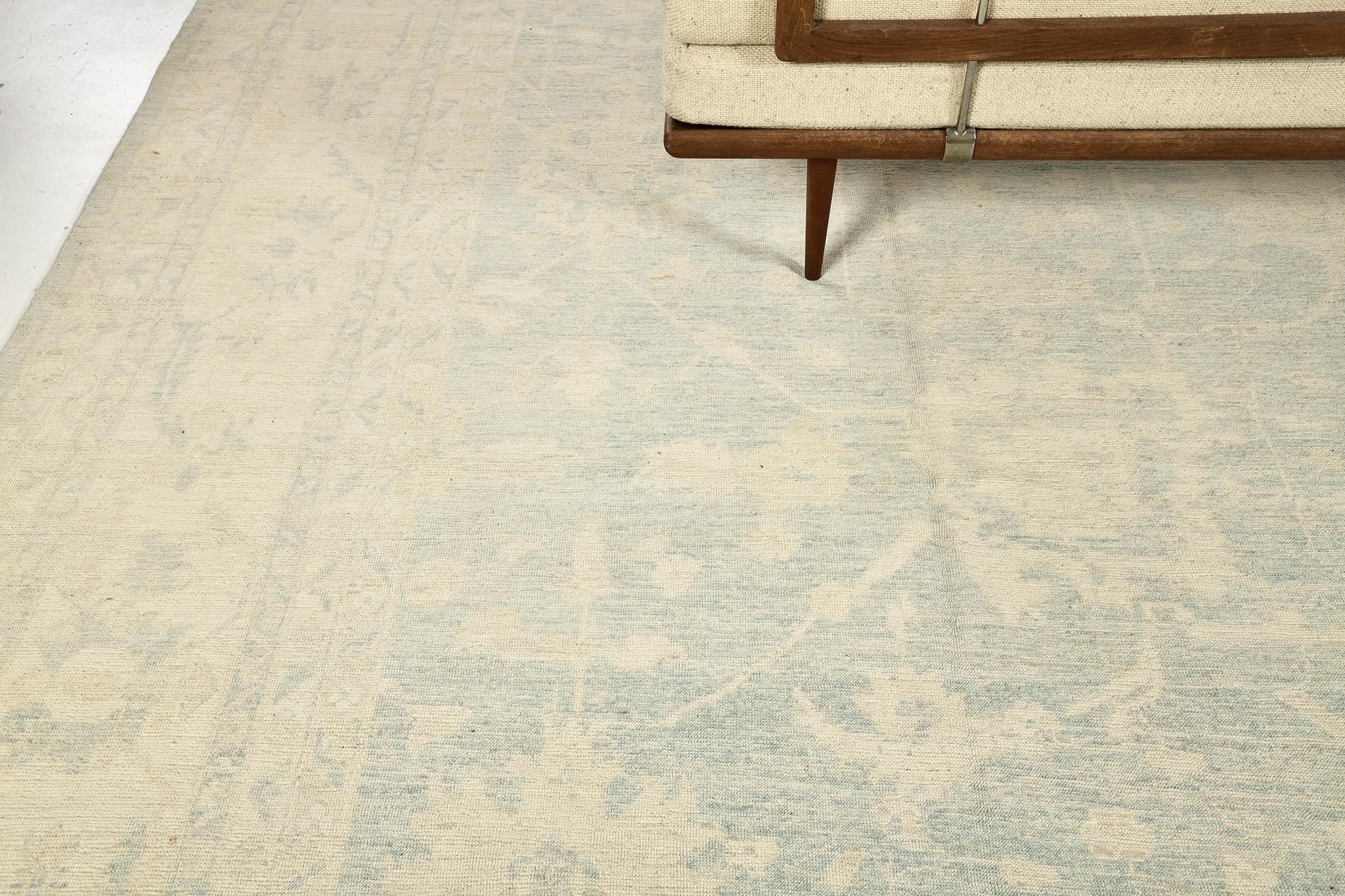 Radiating simplicity through its beauty of a hand spun wool revival of Oushak Rug from Safira Collection. From the lightest ivory to the coolest blue of the florid elements and scrolls. It creates a soulful balance of everything from modern decor to