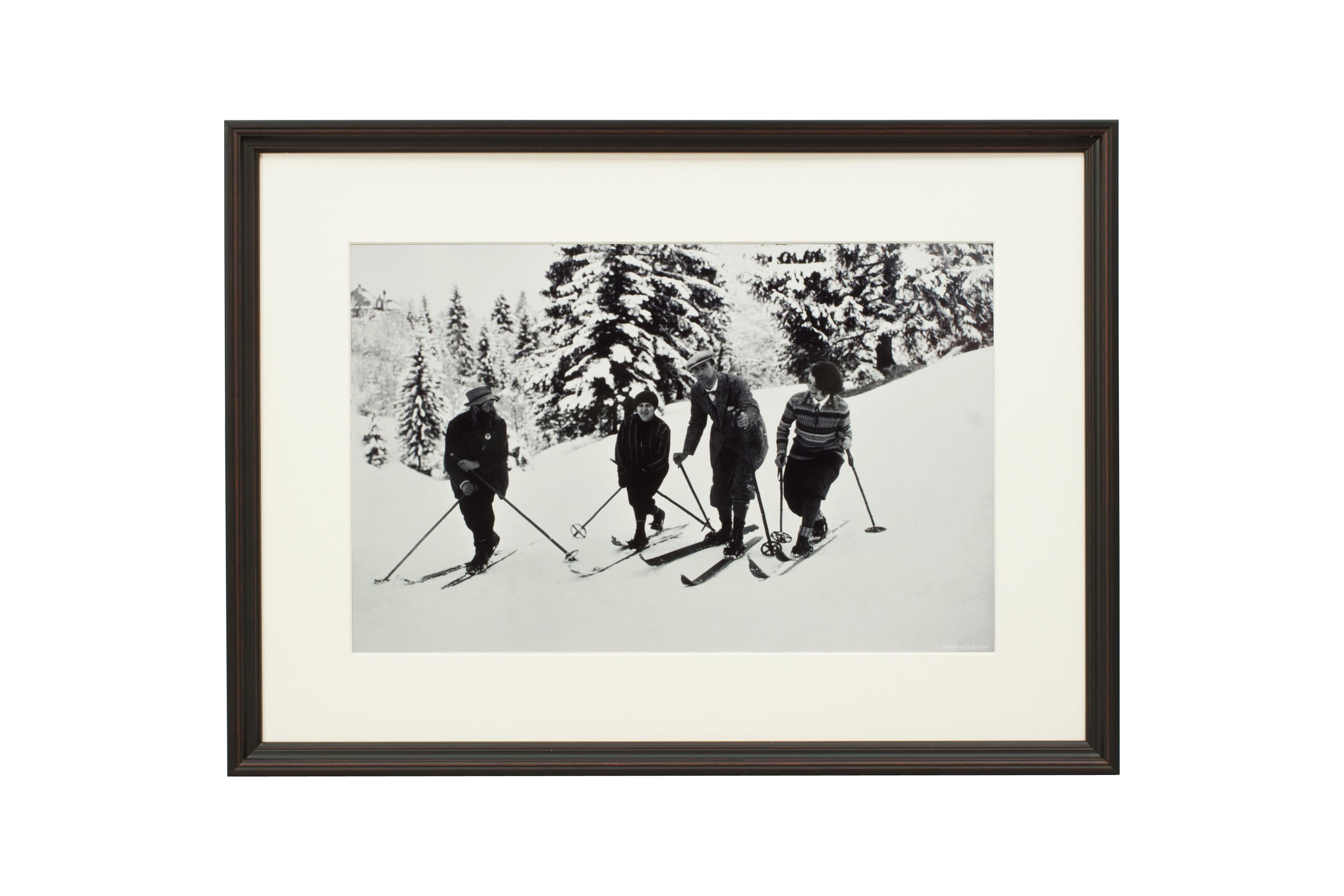 
'BEND ZIE KNEES', a modern framed and mounted black and white photograph after an original 1930's skiing photograph. The frame is black with a burgundy undercoat, the glazing is clarity+ premium synthetic glass. Black & white alpine photos are the
